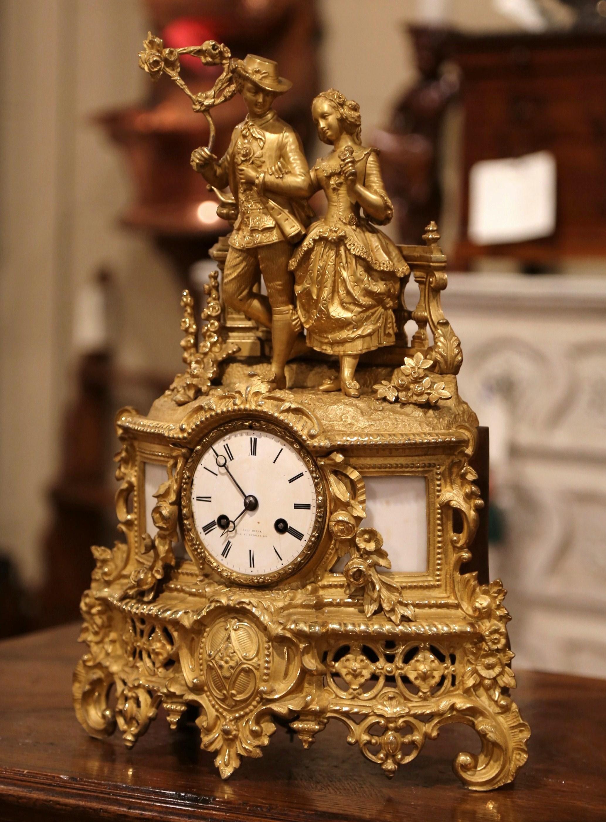 Place this elegant antique bronze and marble clock on a mantel or an office shelf. Crafted in Paris, France circa 1880, the ornate time keeper stands on scrolled feet, and features at the pediment a courting scene with a standing young man and a