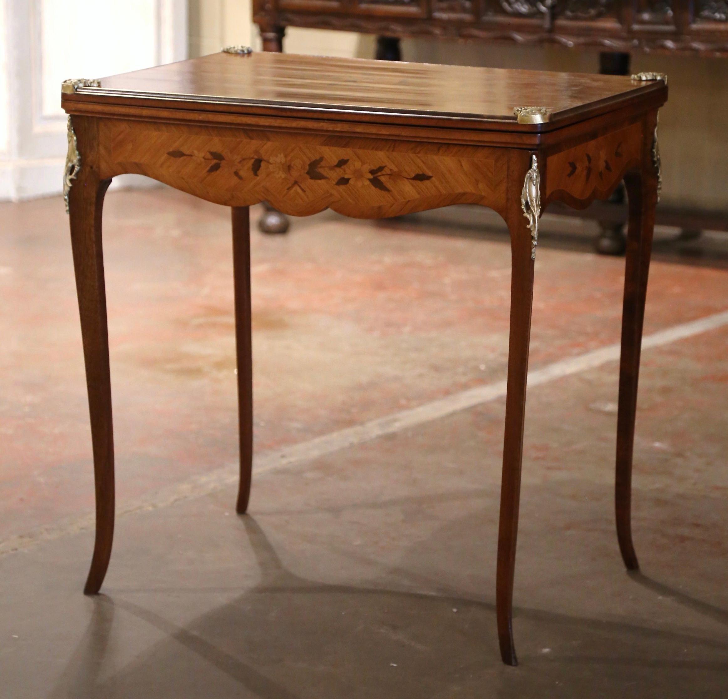Decorate a game room or a den with this elegant folding card table. Crafted in France circa 1970 and built of walnut wood, the table showcases exquisite craftsmanship with delicate marquetry and inlay decor throughout. the rectangular table stands