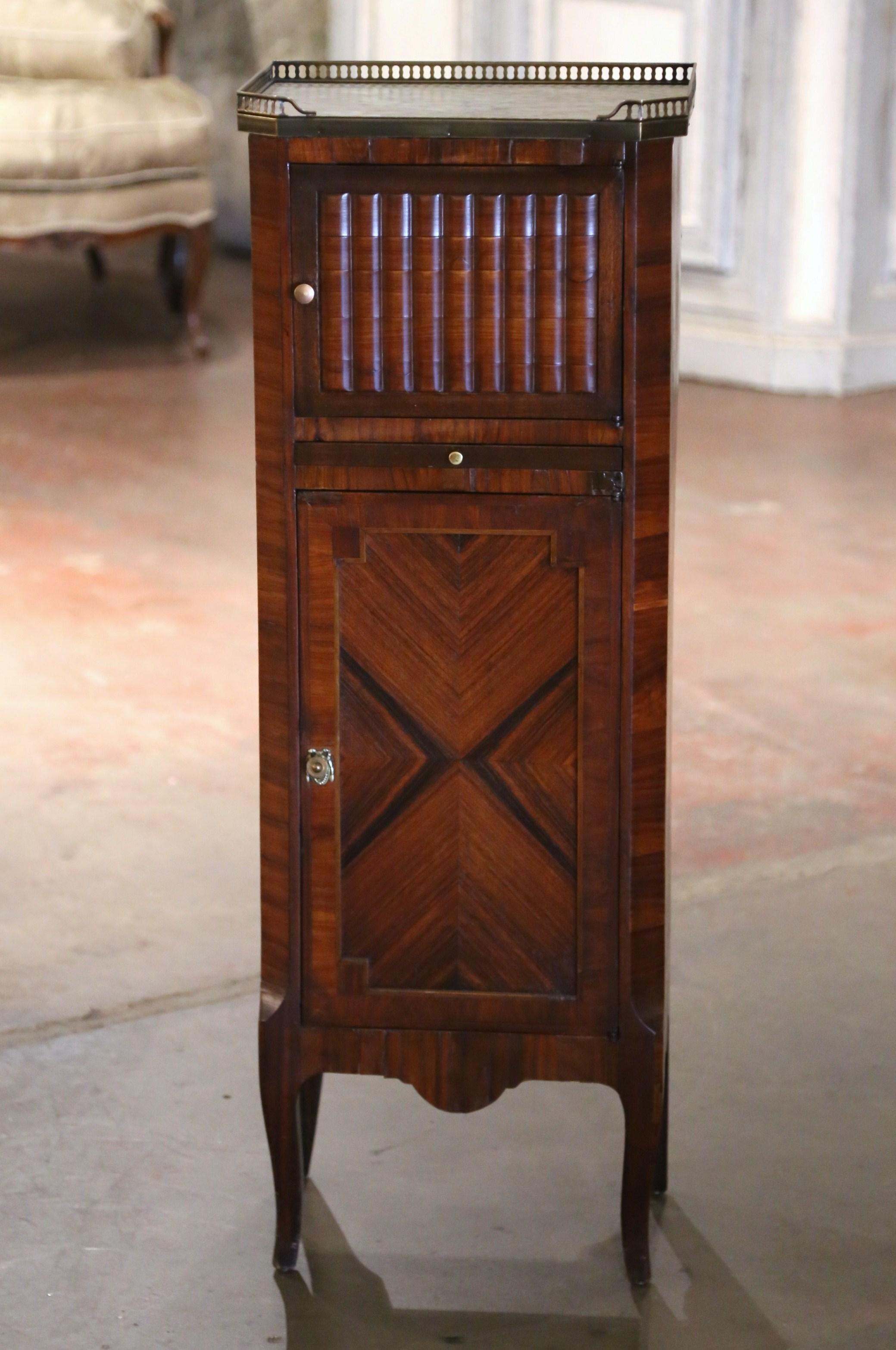 Decorate a powder room, an entry or hallway with this elegant antique cabinet. Crafted in France circa 1880, the tall cabinet stands on cabriole legs. The piece is topped with a delicate marble slab and framed with a decorative brass gallery. The