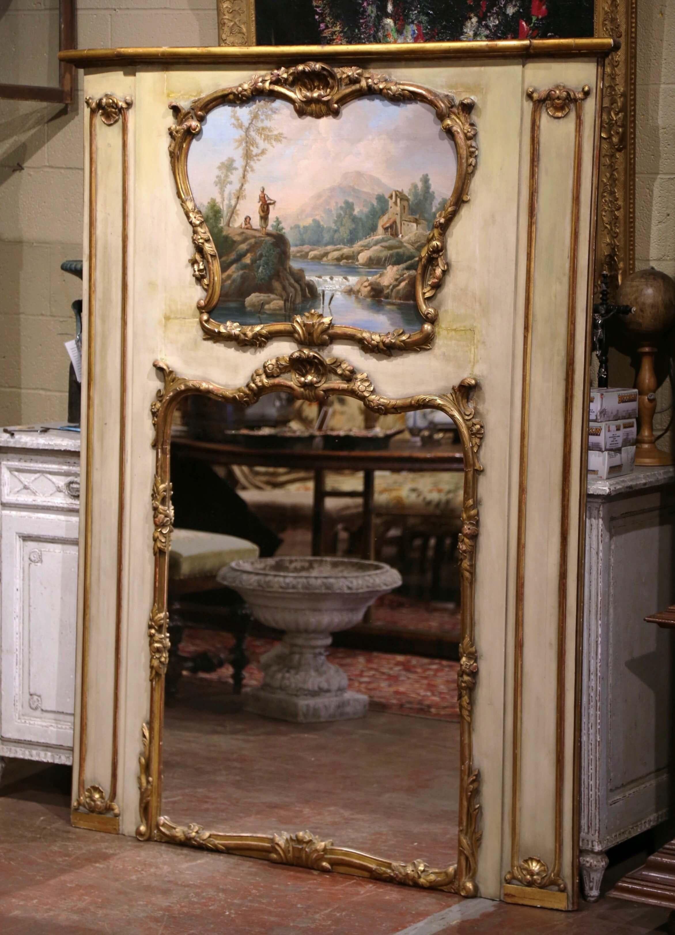 Add beauty and elegance to your living room with this elegant and large antique trumeau. Crafted in France, circa 1880, and over six foot tall, the parcel gilt and painted frame features carved shell and foliate motifs embellished with scrolled