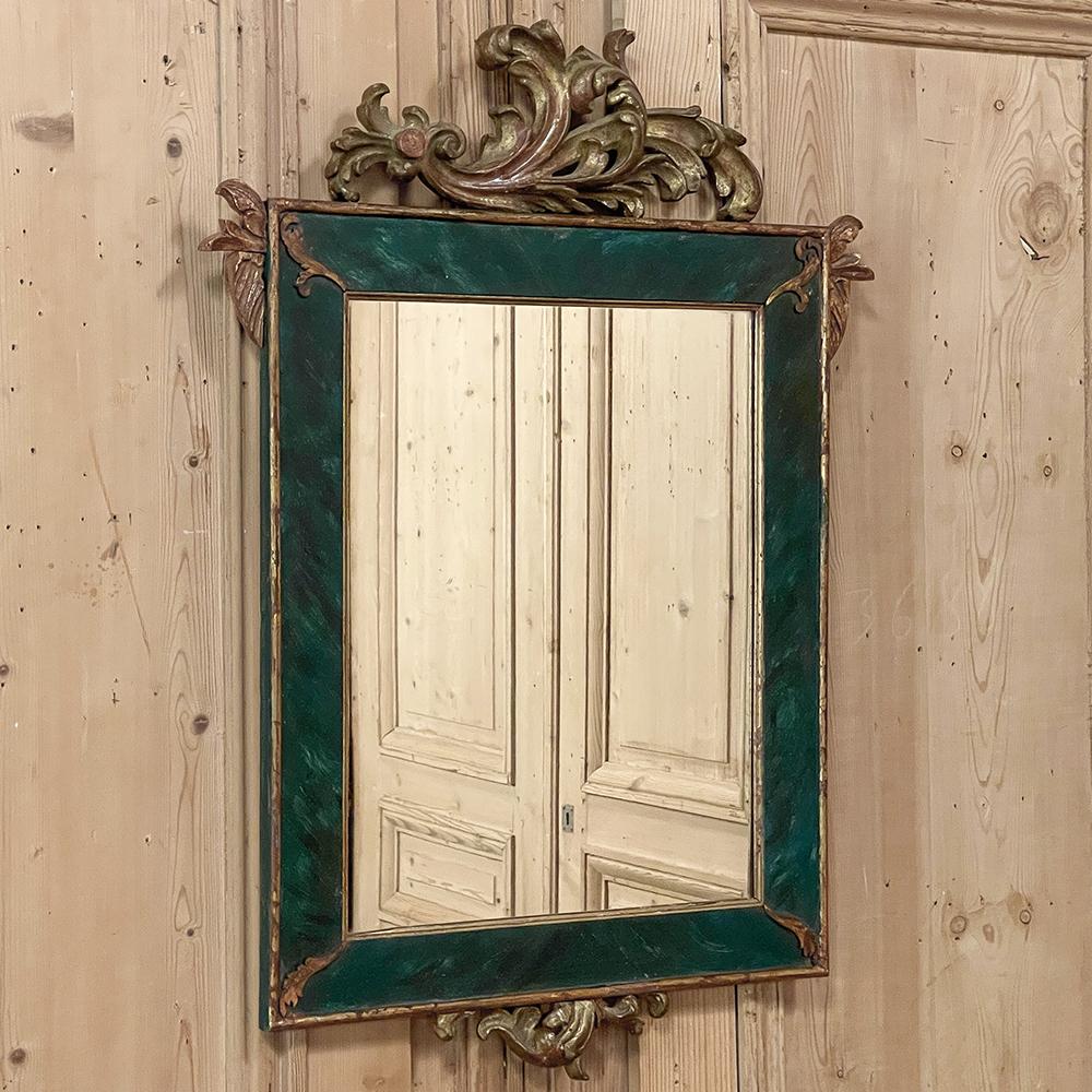 19th century French Louis XV painted & gilded mirror is the perfect size for a cozy niche, hallway or a powder room! Hand-crafted by talented artisans, it features a pine frame with hand-carved sycamore embellishments which include a prominent