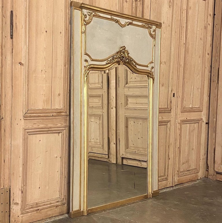 19th century French Louis XV painted and gilded trumeau mirror is a magnificent example of the refined expression of the Louis XV style, influenced heavily by the Rococo movement which combined specific classical elements with an envelope of Baroque