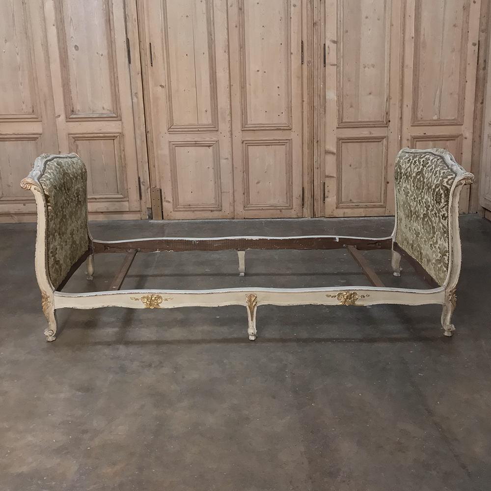 19th century French Louis XV painted upholstered daybed makes a great choice as a sofa, as guest room accommodations, or simply as a place to relax after a hard day's work. Finely carved framework in the Rococo genre is accentuated by the upholstery