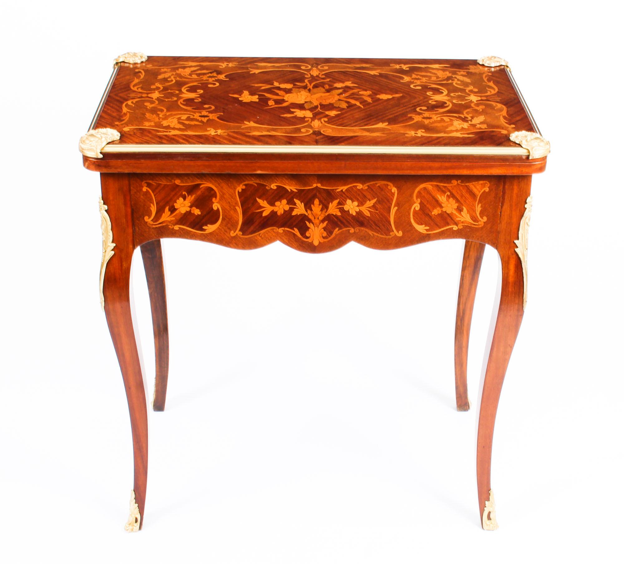 This is a superb antique French Louis XV Revival ormolu-mounted mahogany and marquetry rounded rectangular marquetry card table, circa 1880 in date.

This splendid card table features a folding top which features exquisite floral and foliate