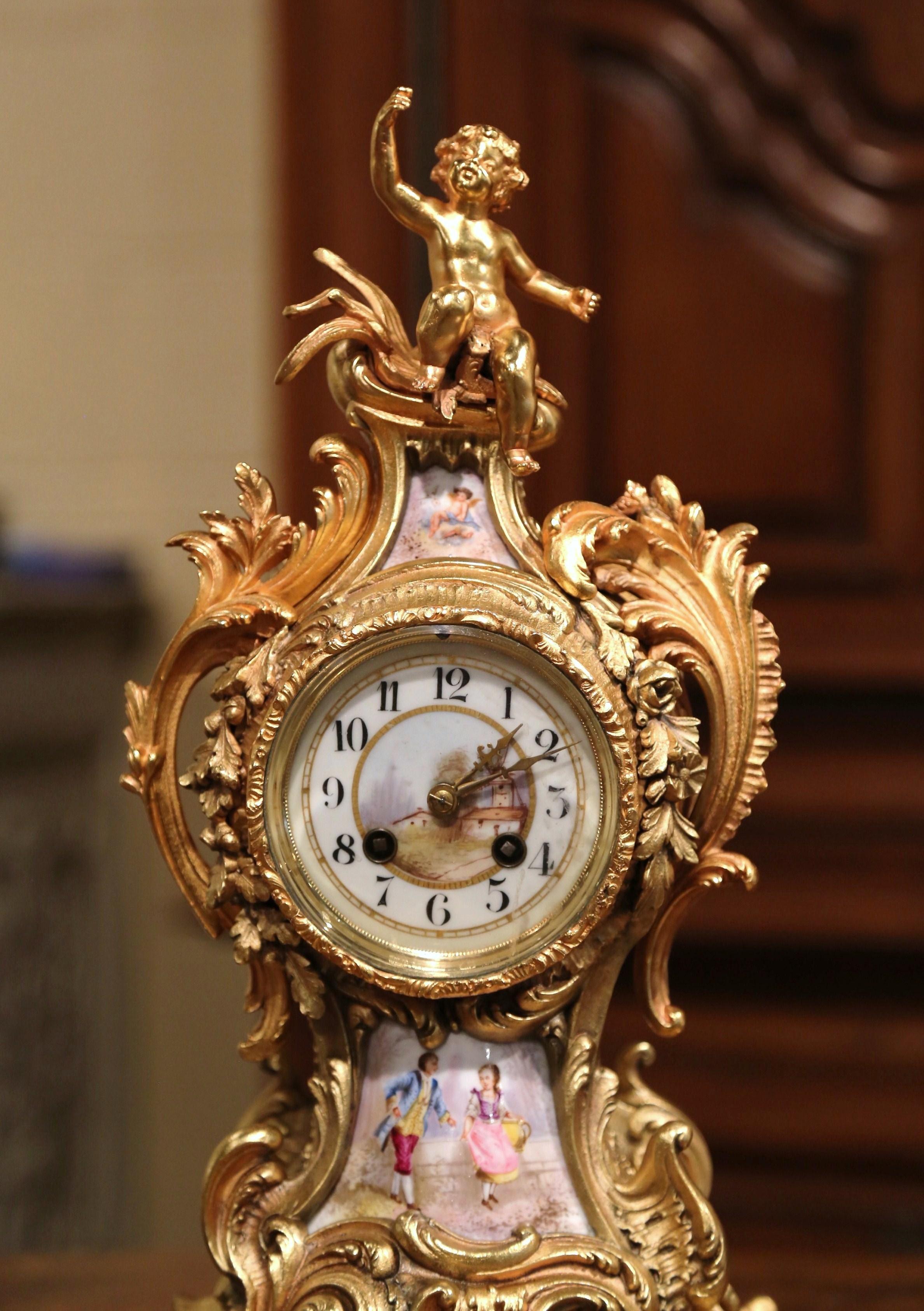 Crafted in Paris, France circa 1860, the antique time keeper stands on an attached intricate base; the clock is decorated throughout with foliage and acanthus leaf motifs embellished with a cherub sculpture at the pediment. The clock is further