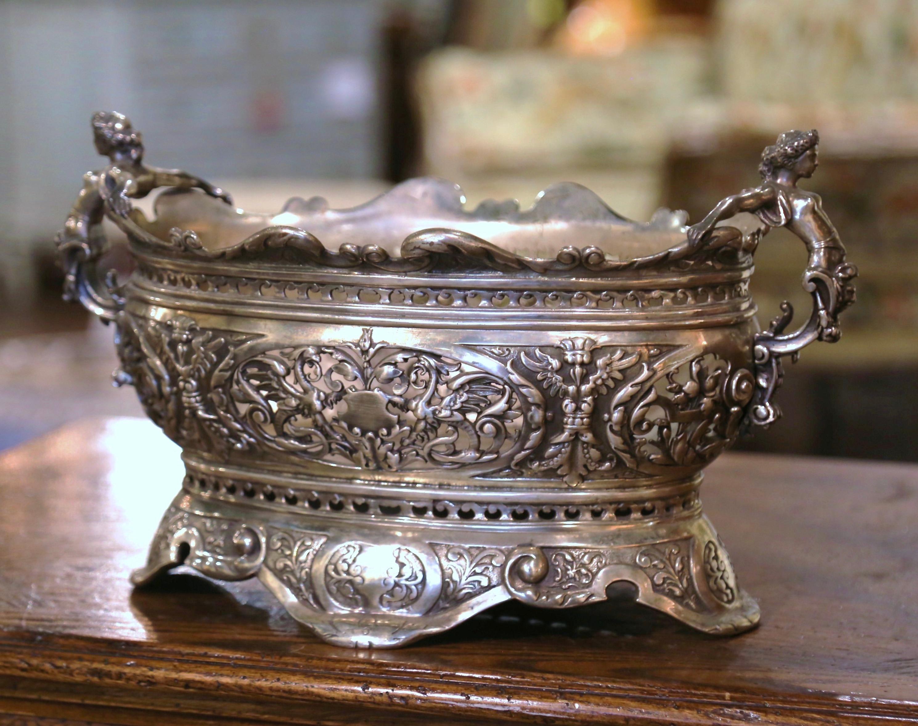 Decorate a dining table with this elegant antique jardiniere. Crafted in Paris, France circa 1870, and made of bronze with silver plate, the planter is oval in shape and dressed with intricate Roman female figure handles over a scalloped rim