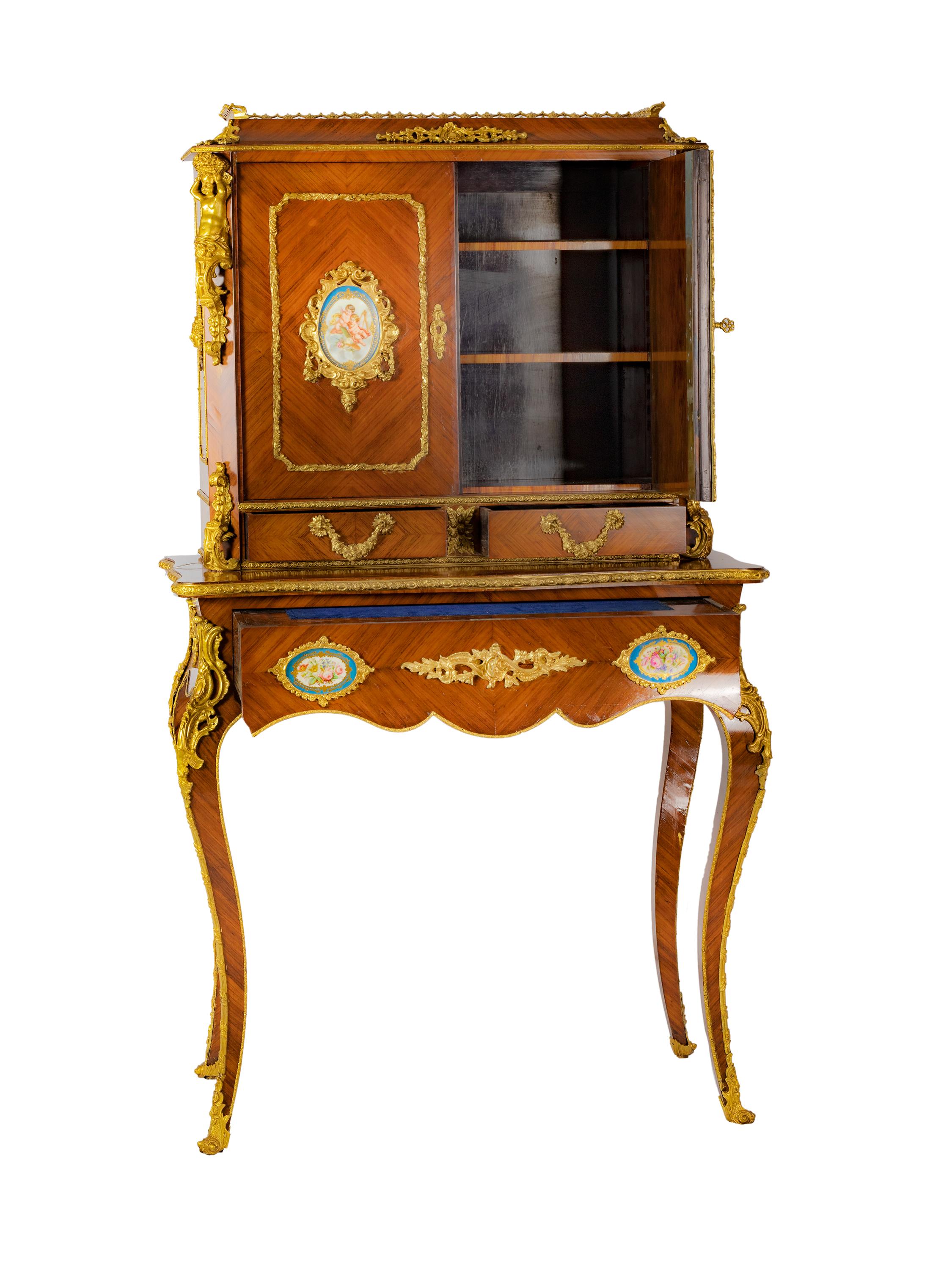A very fine 19th century French Louis XV style with ormolu mounted Bonheur du Jour.
A twin panel door applied with oval Sevres porcelain panels, enclosing shelved interior, the base supported on squared cabriole legs Ormolu mounted details and