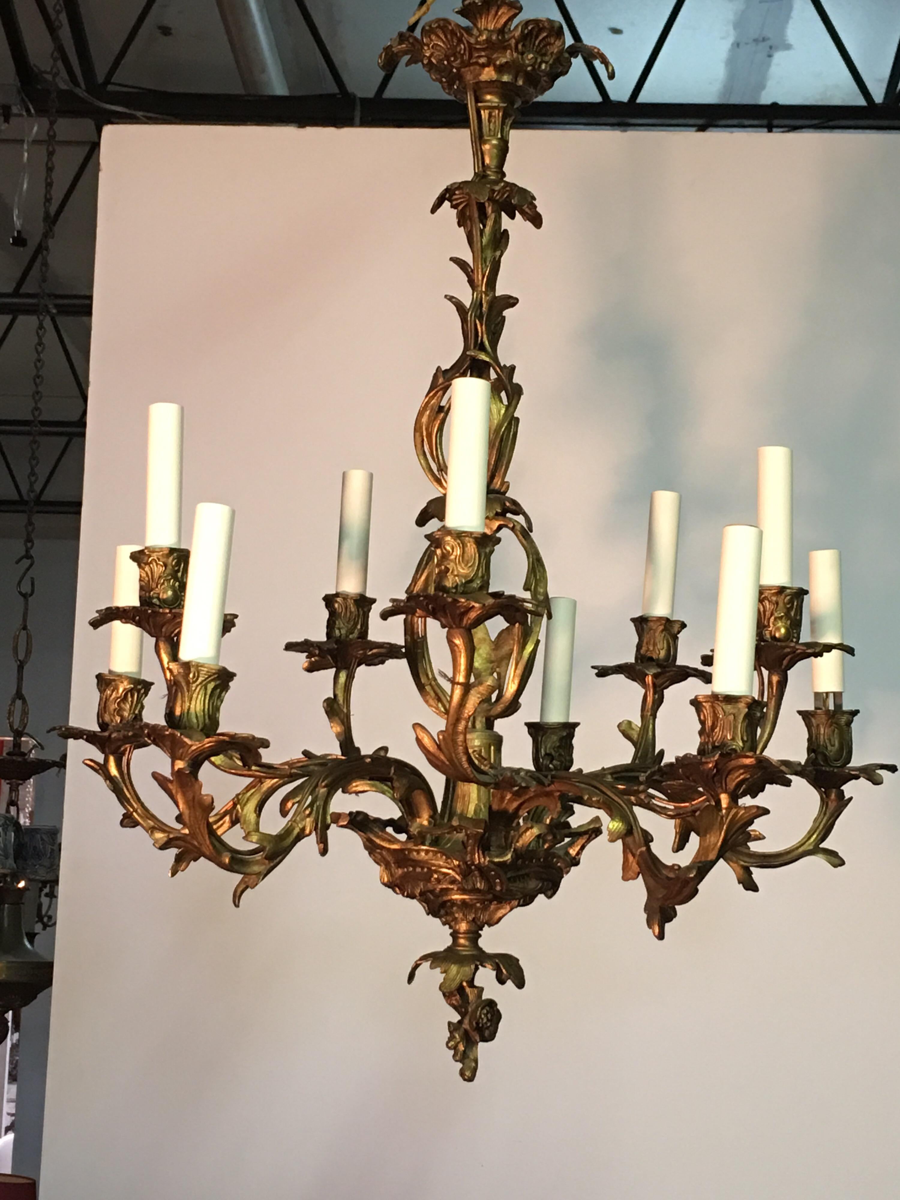 French Louis XV style bronze chandelier from the late 19th century. This Rococo style ten-light chandelier is cast bronze and has an asymmetrical foliage motif throughout. The scale of the chandelier allows its use in various locations.