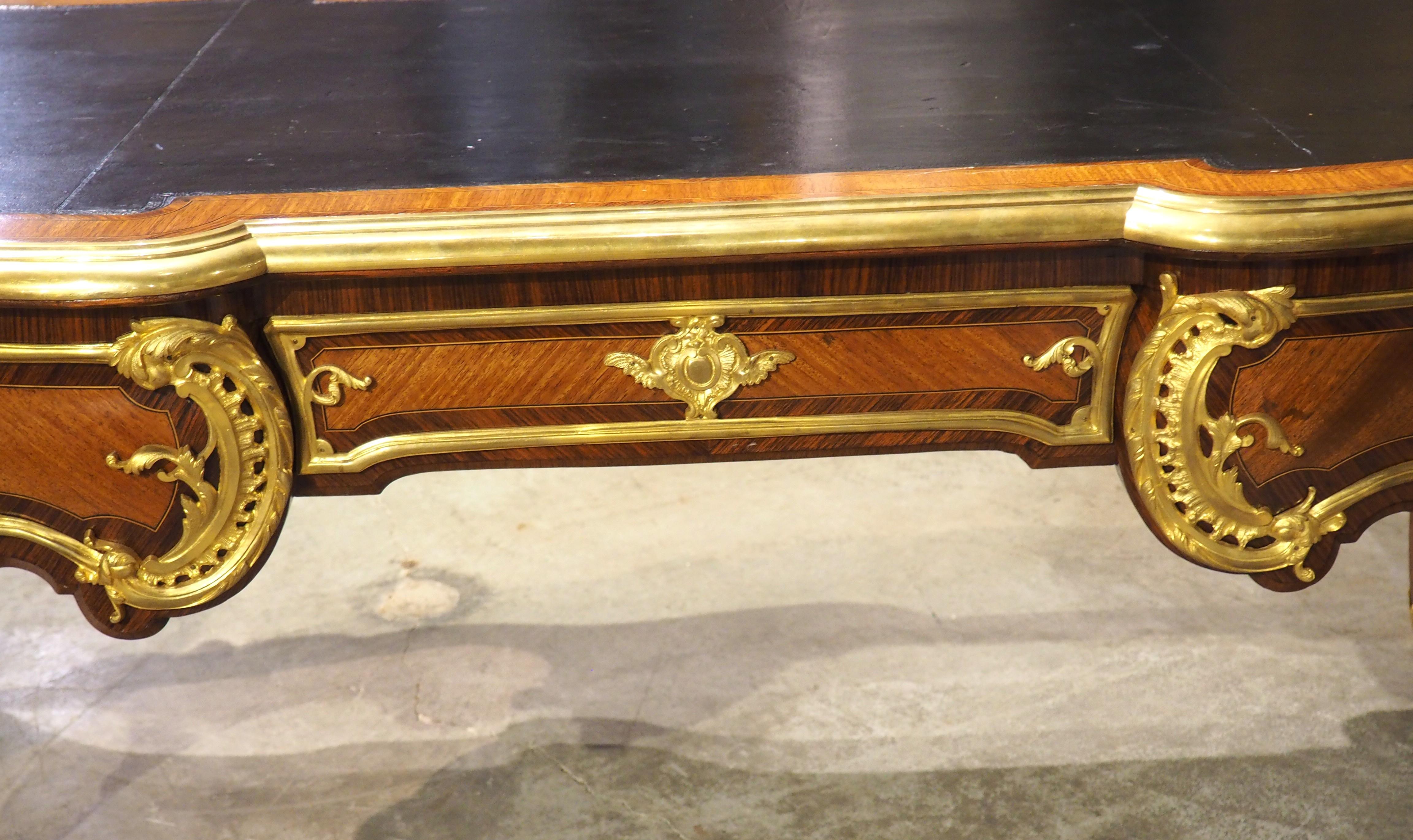 Modeled after the original period Louis XV bureau plat by Charles Cressent (circa 1740), this amazing French desk would be the focal point for any home office or executive business suite. In the 1800s, when ours was crafted, premier Parisian