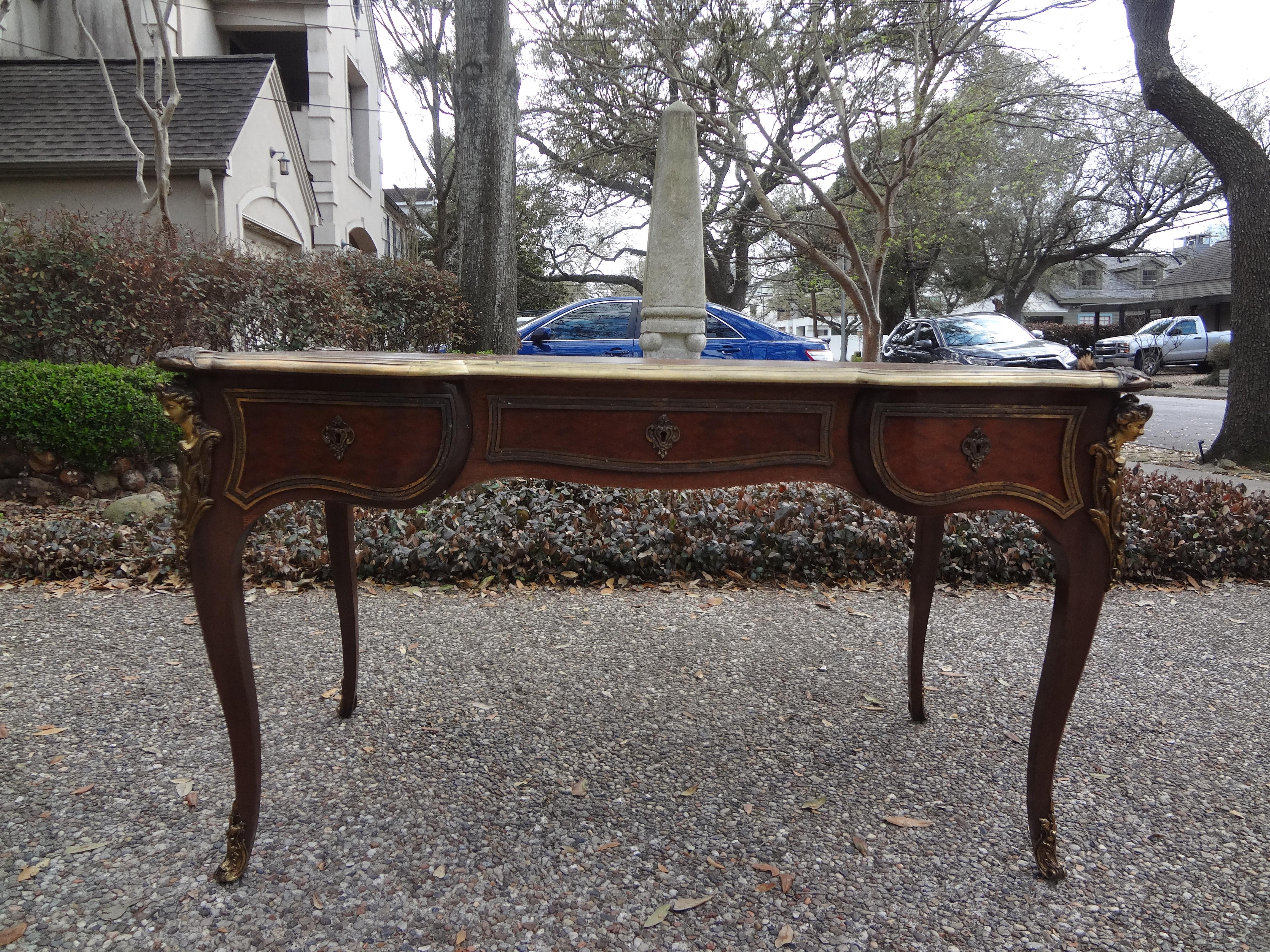 Stunning 19th century French Louis XV style desk- bureau plat. This beautiful 19th century French Napoleon III kingwood desk, writing table, or bureau plat is finely detailed with the original brown gilt embossed leather top and three drawers,