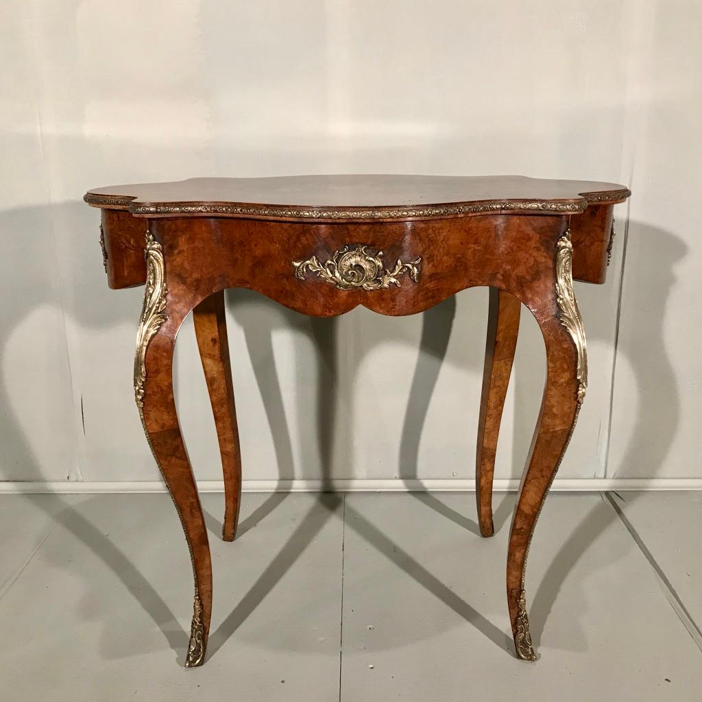 Very beautiful and fully restored French burr walnut and marquetry centre table with a fantastic set of brass mounts.
Very decorative and useful table, certainly as a side table or lamp table, but if you have the space to place it as a centre