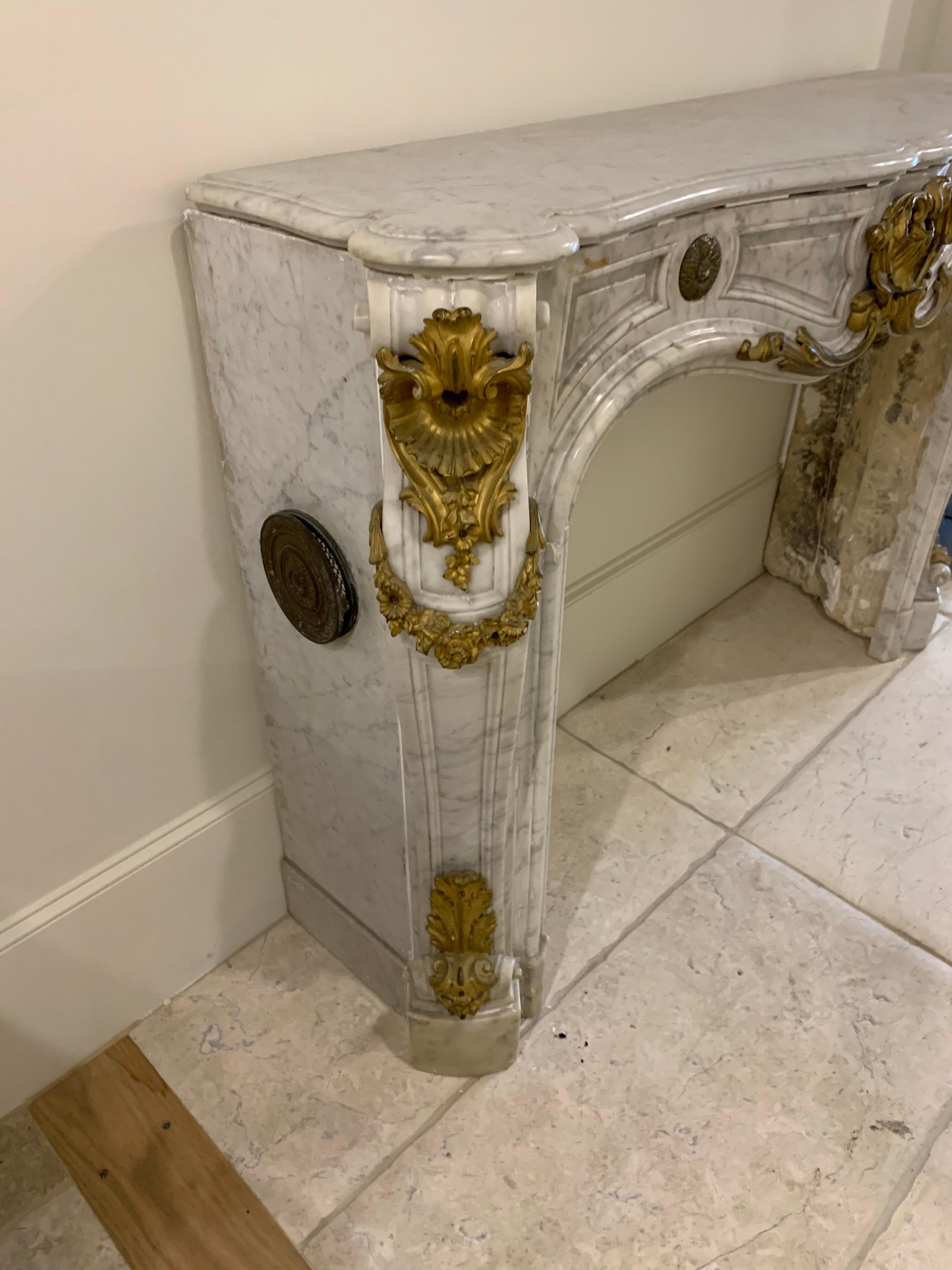 Fabulous 18th century French Louis XV style Carrara marble and gilt bronze mantel. 
Beautiful marble and nice decorative designs on the gilt sections. Very elegant for a fine home!