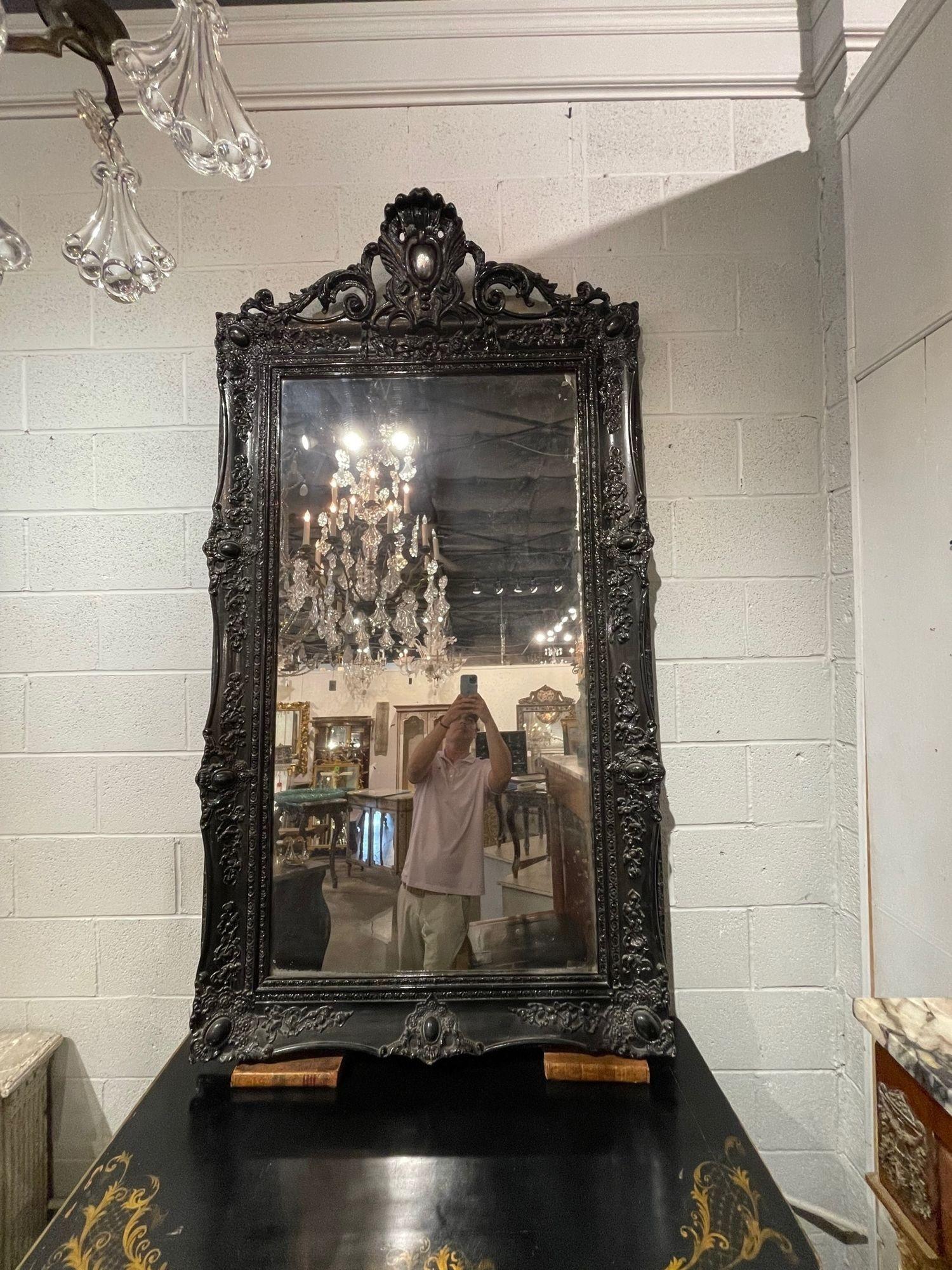 Very fine large scale 19th century French Louis XV style carved and black lacquered mirror. This piece has exceptional carvings including a crest at the top.
