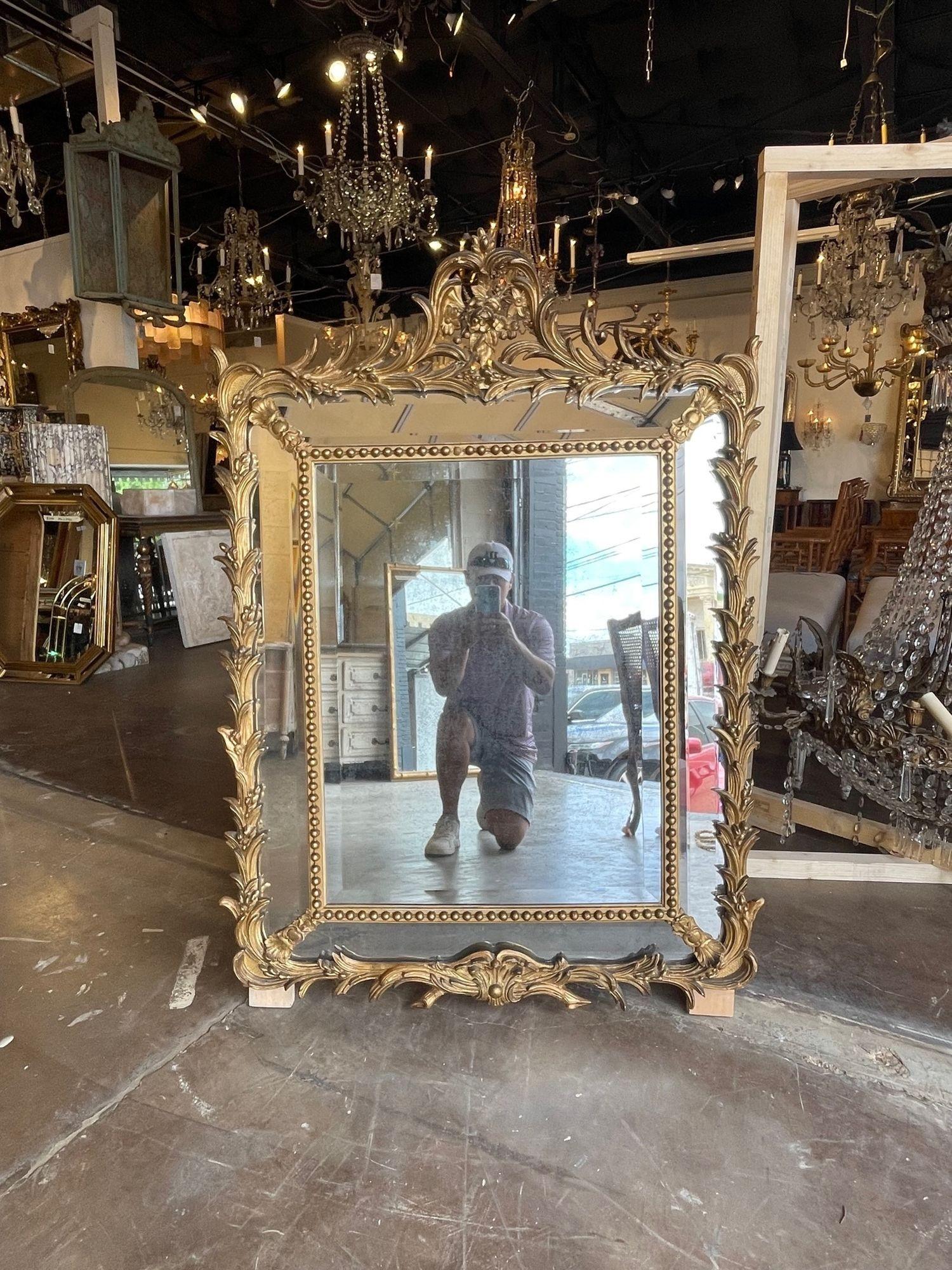Exceptional 19th century French Louis XV style carved and gilt wood mirror. Beautiful carving including an elaborate crest with leaves at the top. Creates a very elegant look! Superb!