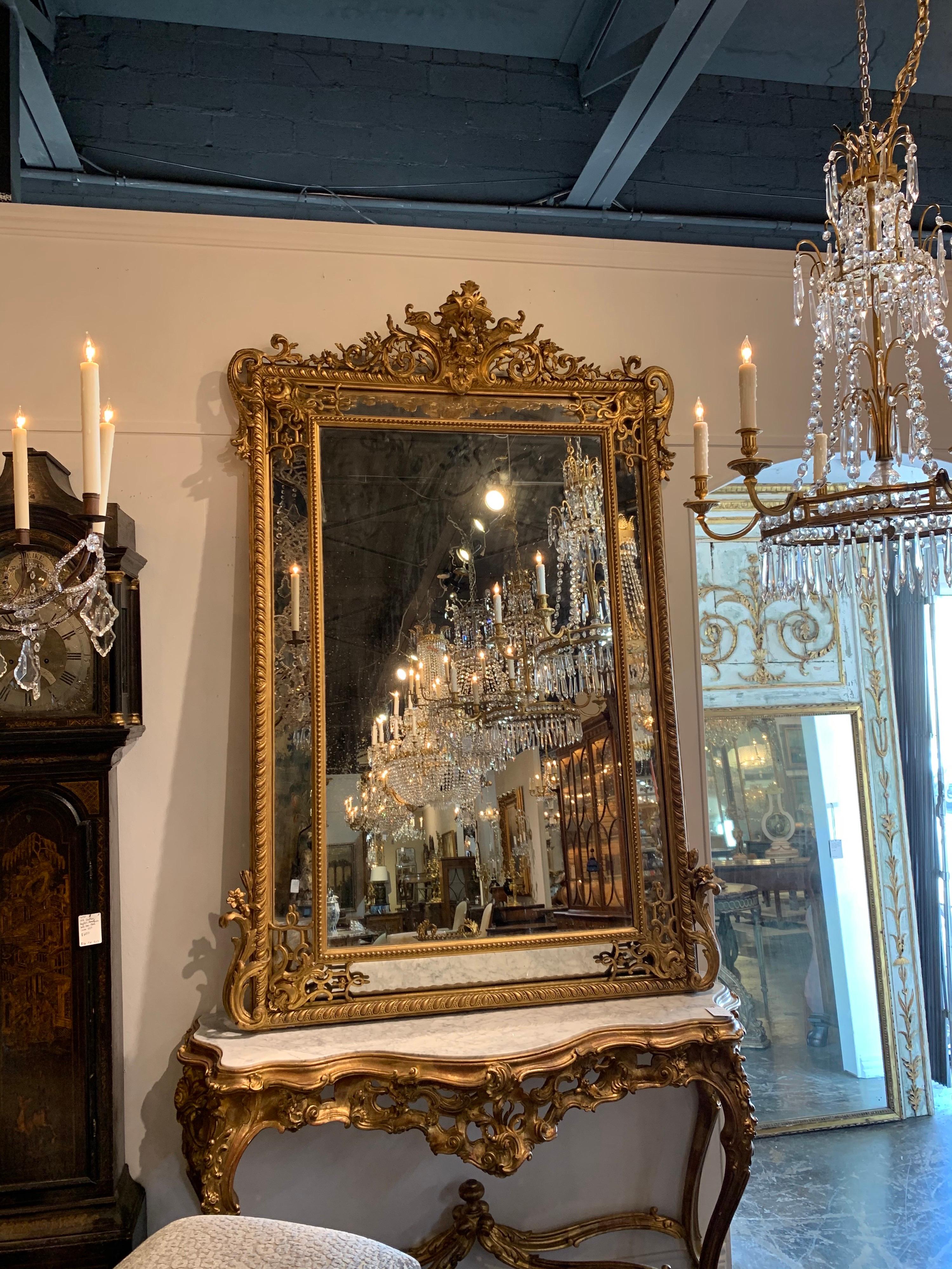 Stunning 19th century French Louis XV style large scale carved and giltwood cushion mirror. Very fine carving on this mirror including scrolling and floral images.
Exceptional quality!