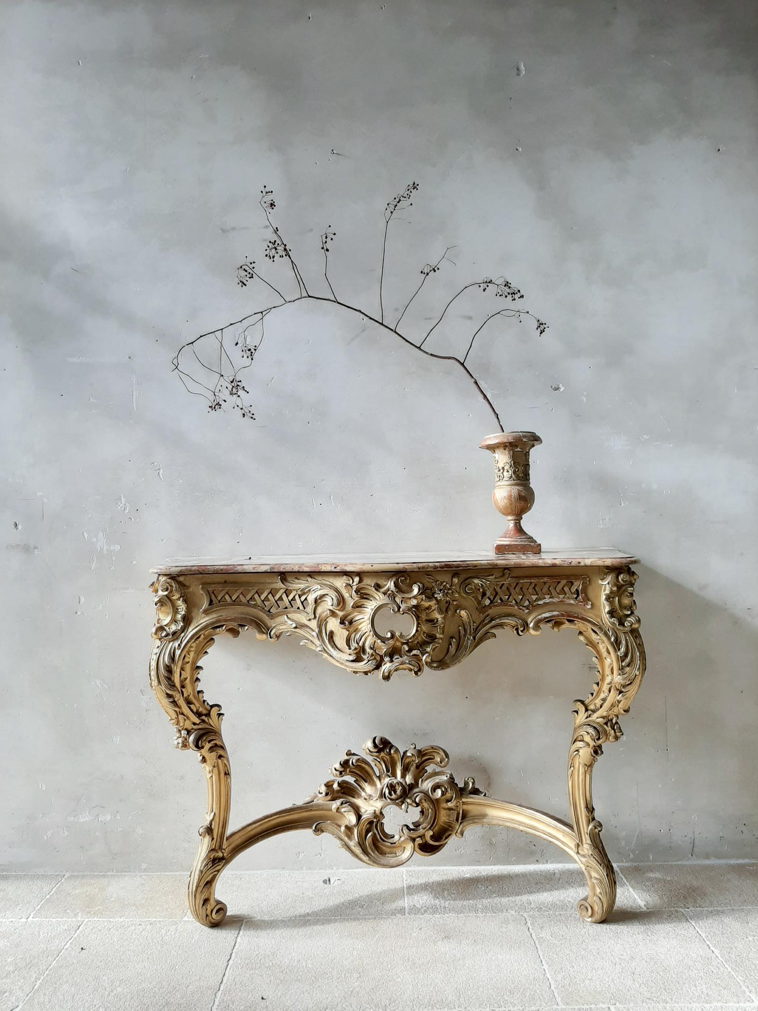 Beautifully carved and giltwood console table with shapely marble top. French, Louis XV style, 19th century. 
Completely and very richly carved wood (no gesso ornaments), having elaborate and Fine carvings of acanthus scrollwork.
The front and