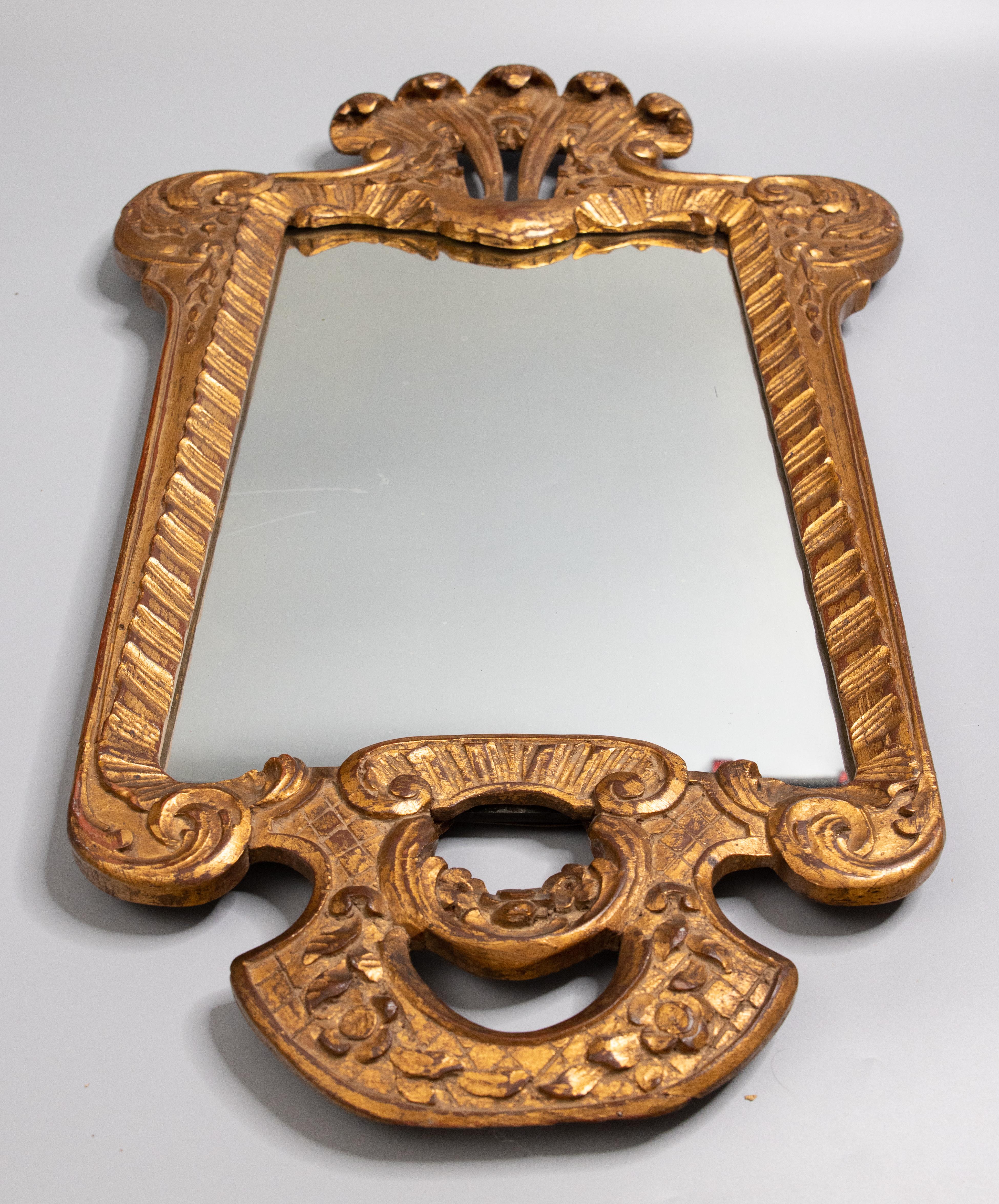 A superb antique 19th-Century French Louis XV style giltwood elaborately carved mirror with original glass, circa 1850. Signed by the maker on reverse. This lovely mirror has floral decorations and scroll designs in a beautiful gilt patina. It would
