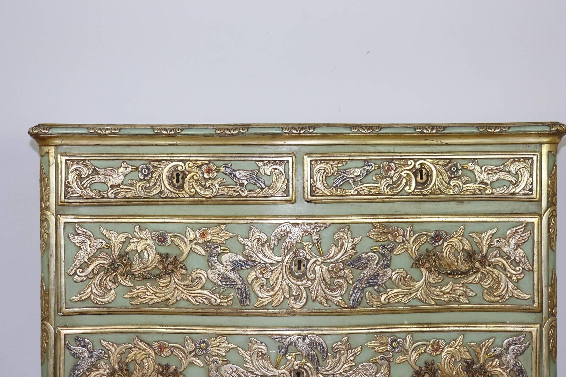 Beautiful rare antique dresser made in the first half of 1800s. The line is in perfect Louis XV style rich and sumptuous French rococo. The chest of drawers is in pale green lacquered wood with carved decorations, flowers and birds. The decorations