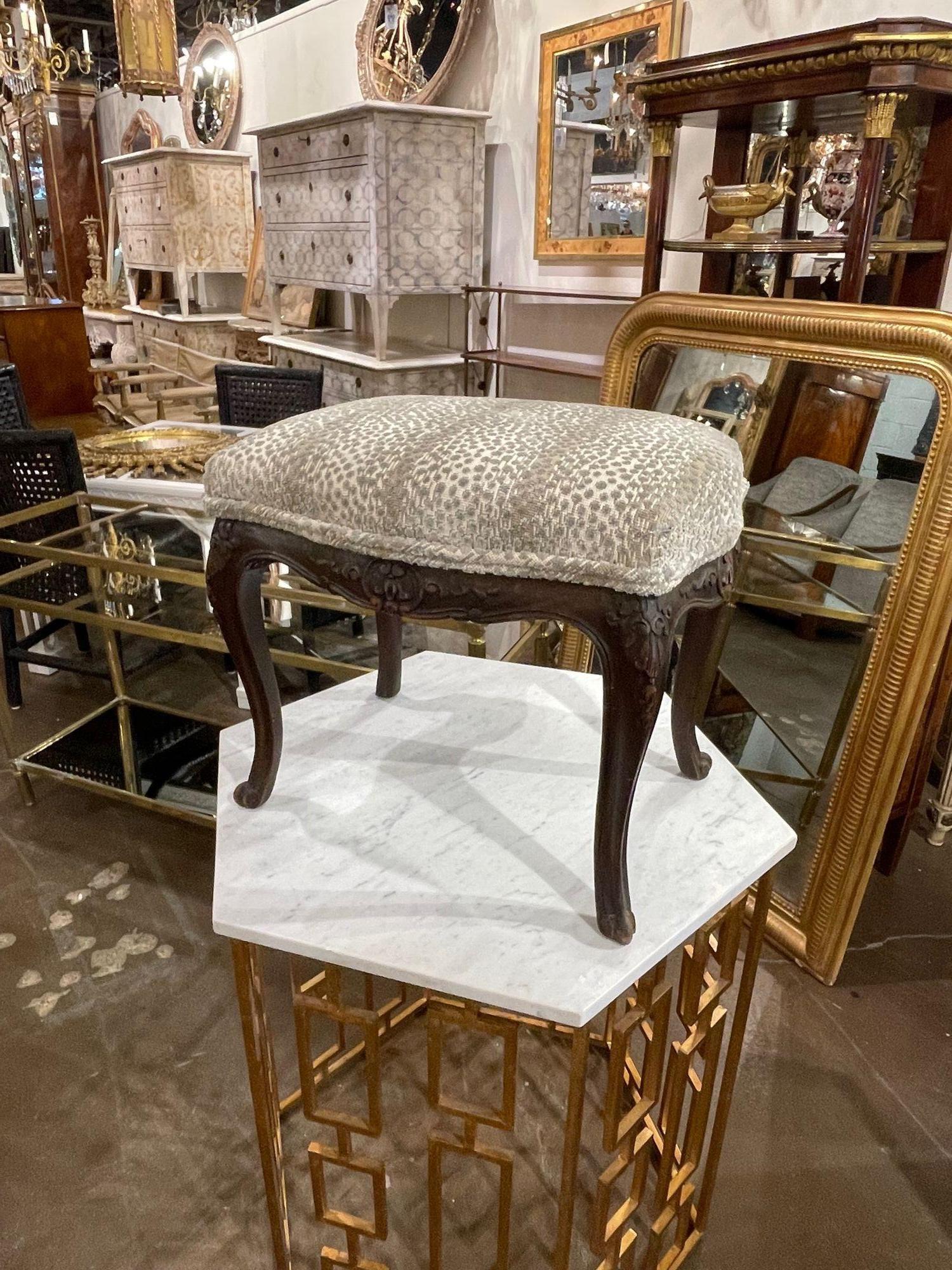 Lovely 19th century French Louis XV style carved walnut stool. Upholstered in a beautiful velvet fabric with a leopard print. Creates an elegant touch!