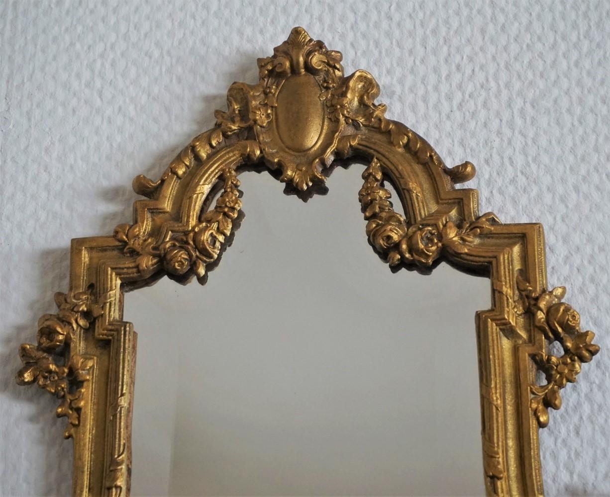 A lovery Louis XV style faceted crystal glass mirror with an elaborate solid gilt bronze frame richly ornate with foliage, garlands and torches, France, mid-19th century.
Measures:
Height 19 in (48.5 cm)
Width 15 in (38 cm).
 