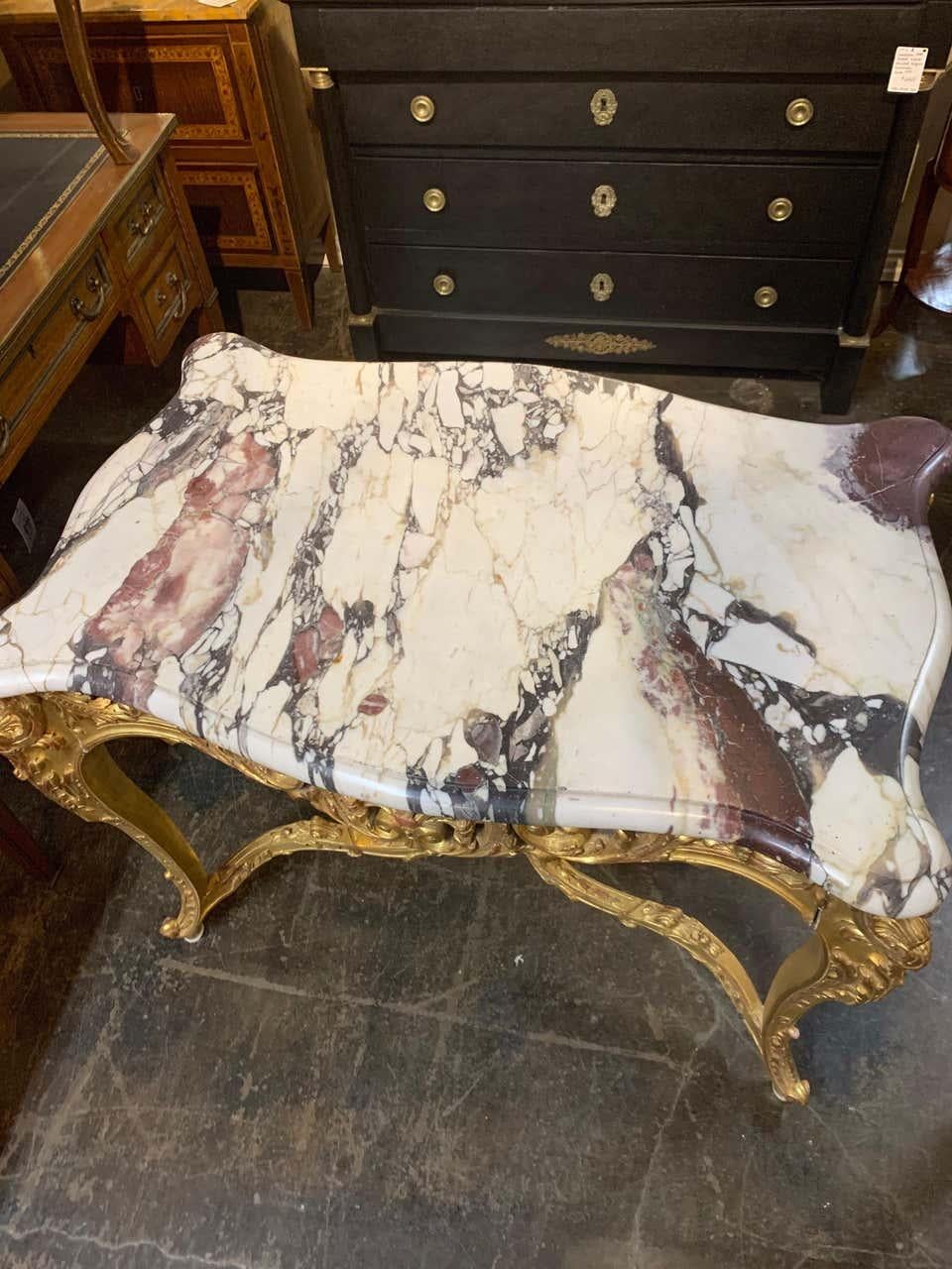 Exceptional 19th century French Louis XV style giltwood center table with breccia violetta marble. Very fine carvings and gilt make this extra special. Gorgeous piece of marble as well!