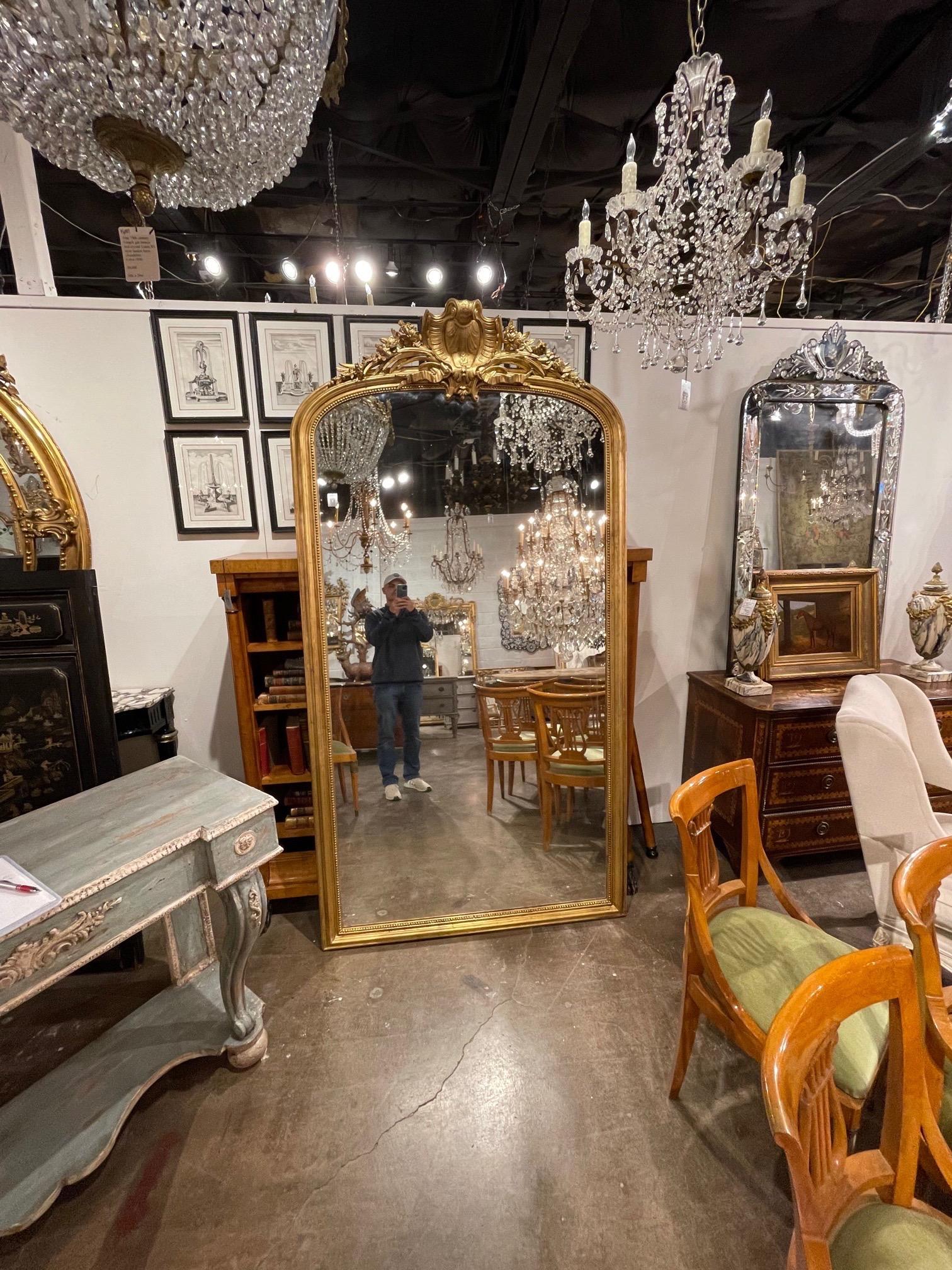 Large scale 19th century French Louis XV style giltwood floor mirror. Beautiful carved details including flowers and a crown at the top. Very impressive!!