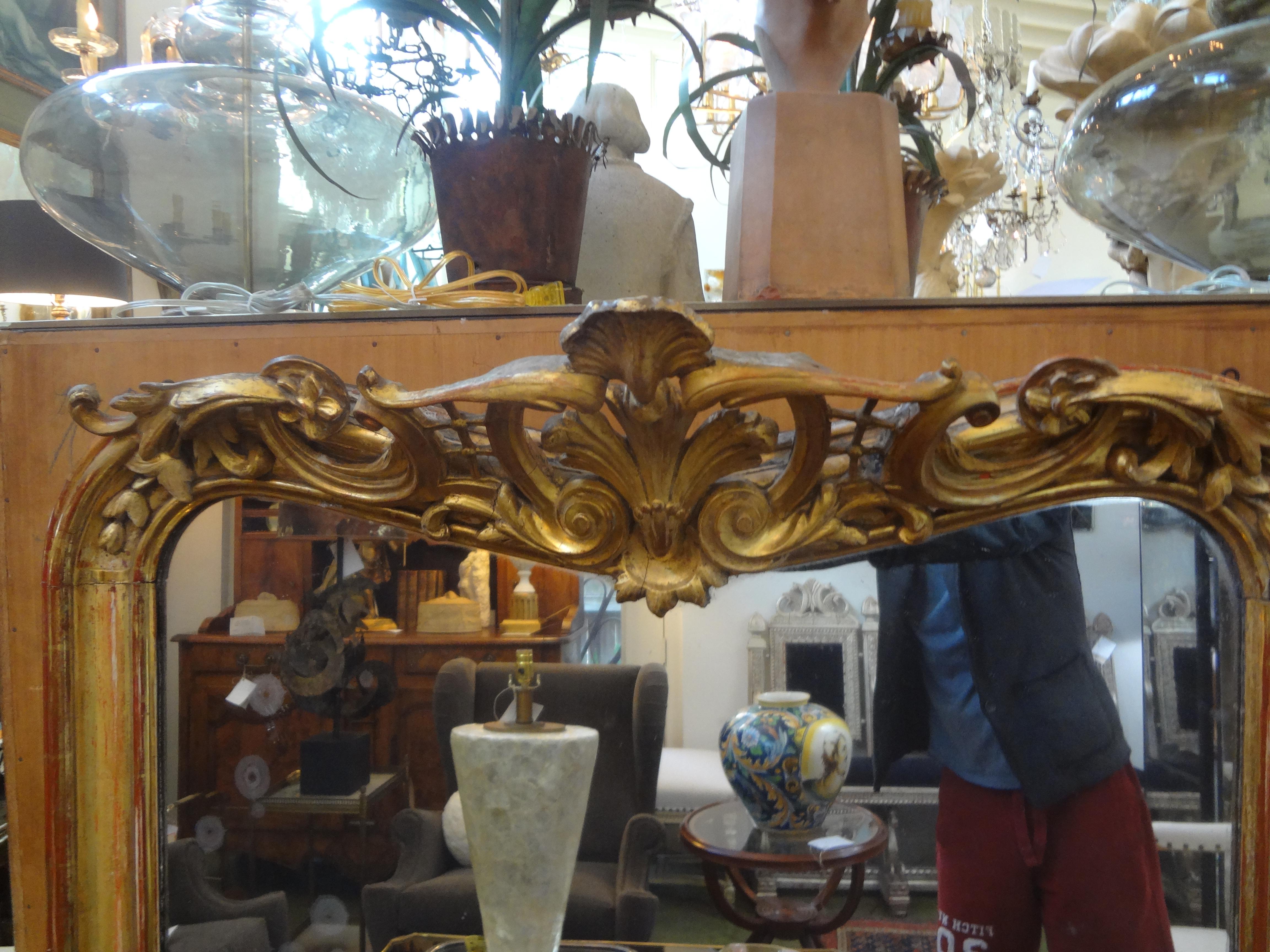 Gorgeous 19th century French Louis XV style giltwood mirror with a lovely cartouche at the top. This antique French full-length gilt mirror has fabulous patina and the back is as beautiful as the front! This stunning French gilt wood mirror would