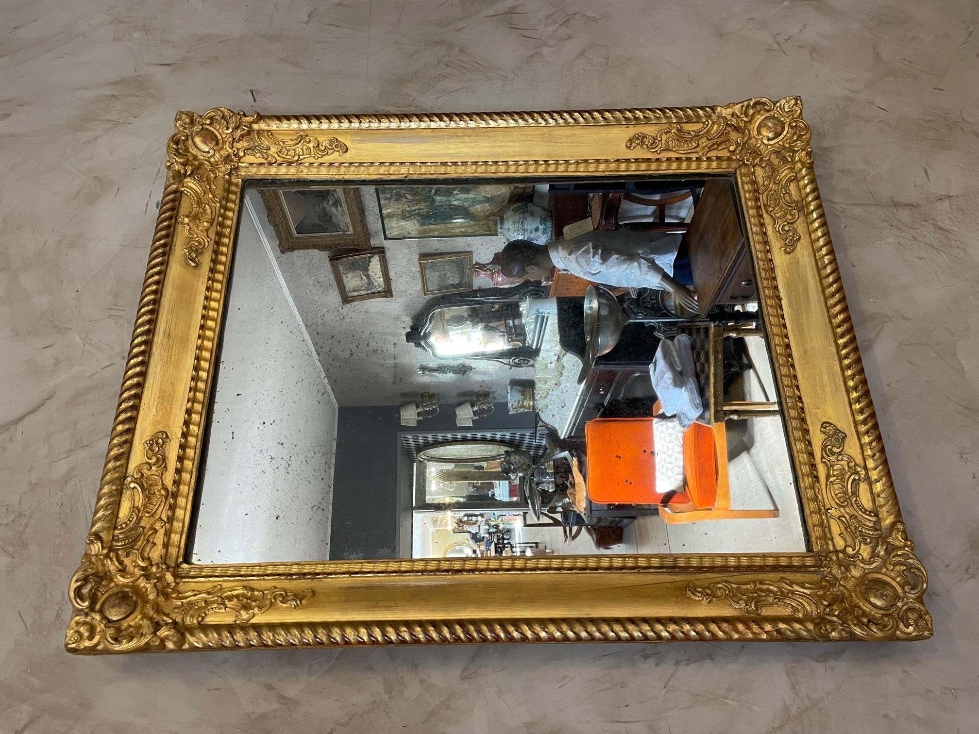 Beautiful 19th century French Louis XVI style mirror made in golden stuc and wood. 
Very nice quality and condition. 
Mercury traces in the mirror. 
A hook at the back to hang up the mirror.