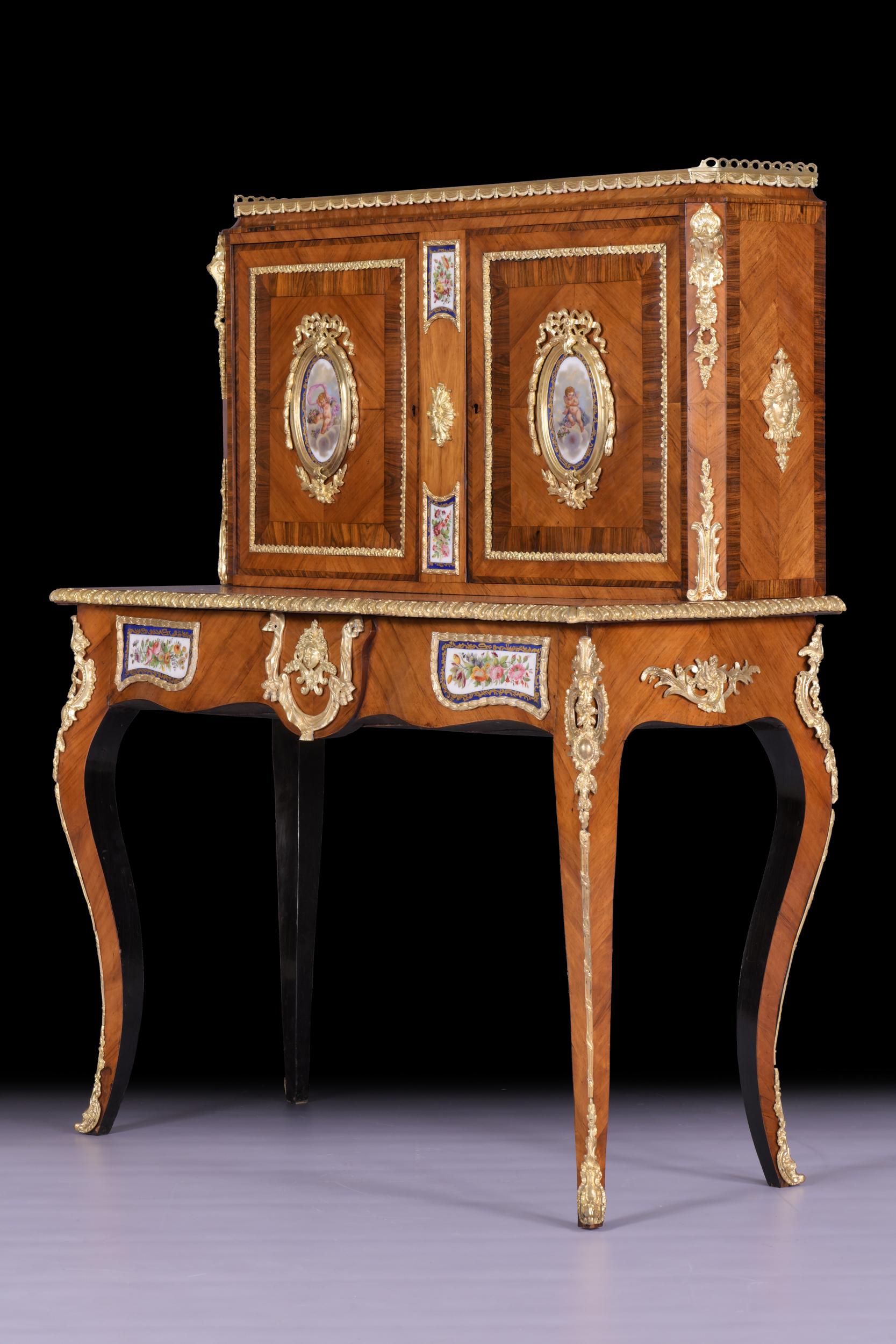 A very fine 19th century French Louis XV style Kingwood, Walnut and ormolu mounted Bonheur Du Jour, the superstructure fitted with twin panel door applied with oval 'Sevres' porcelain panels, enclosing shelved interior, the base supported on squared