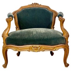 Fauteuil de salon du XIXe siècle en bois doré sculpté et velours