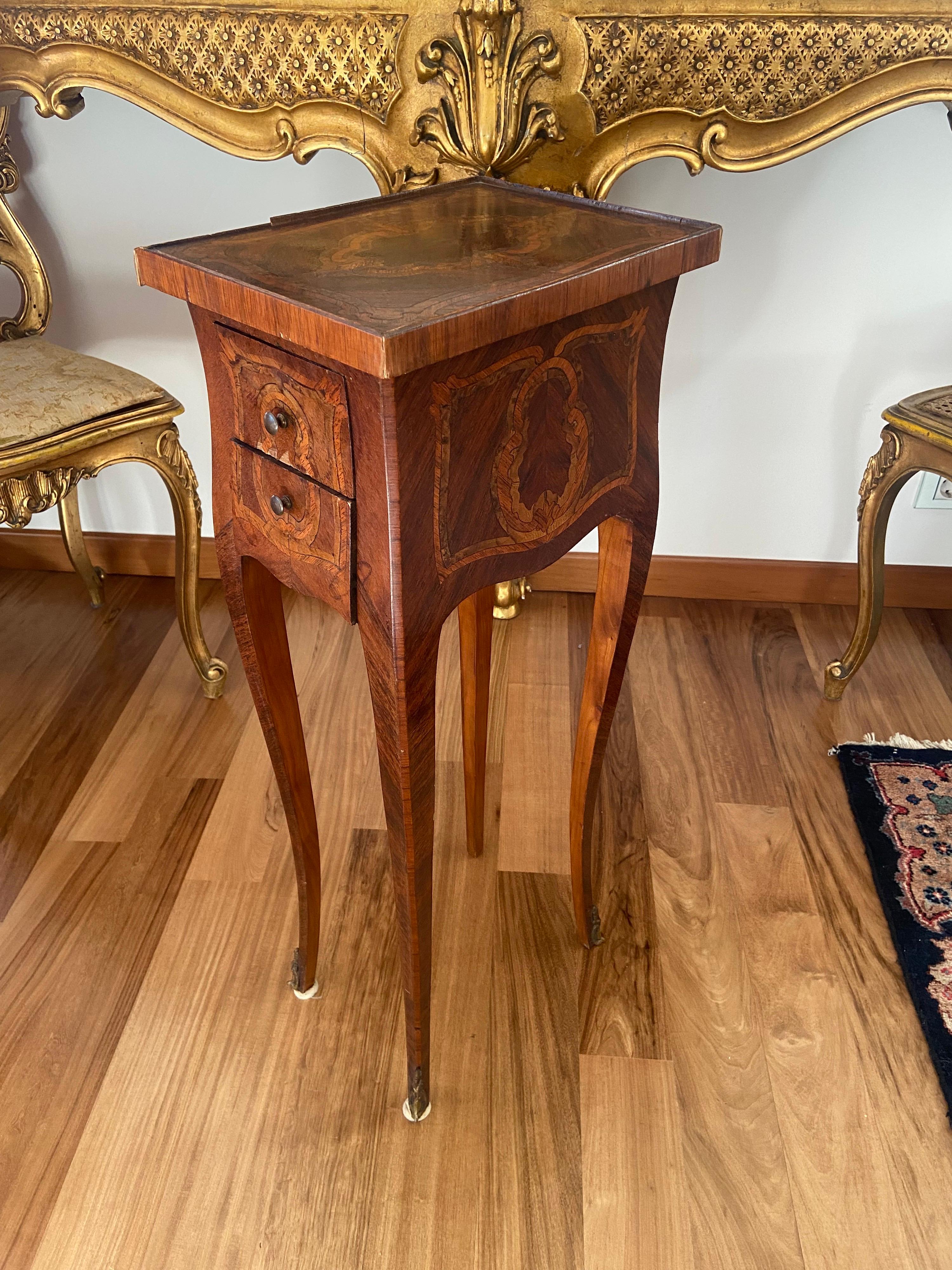 19th century French Louis XV style marquetry side table with two elegant side drawers, resting on long legs. There is a small hidden writing shelf right under the top on the other side of the drawers.
France, circa 1880.