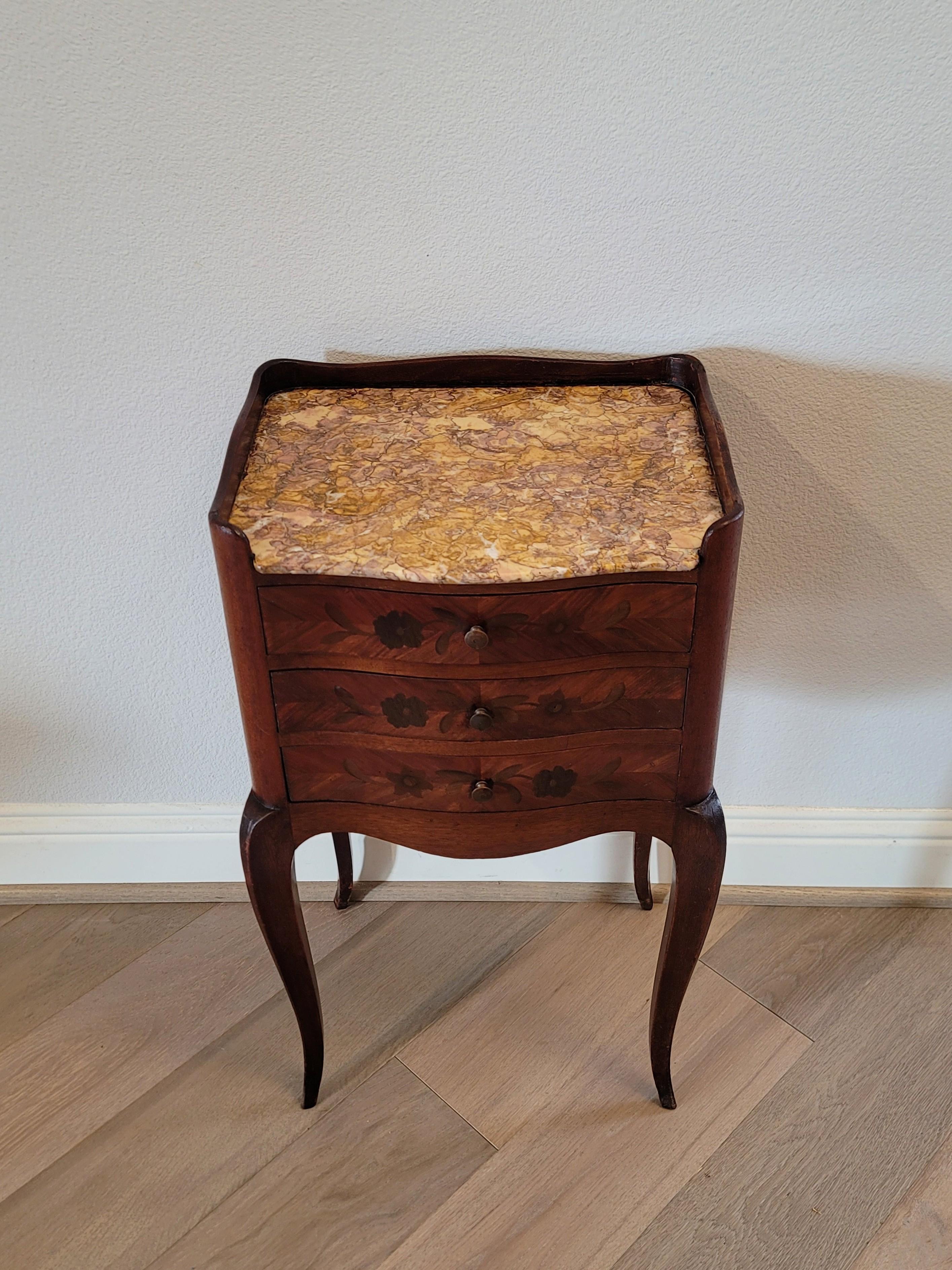 A scarce elegant French Louis XV style nightstand with beautifully aged warm mellow patina.

Born in France in the 19th century, having a partial undulating gallery framing the visually striking brocatelle marble top with dramatic graffiti