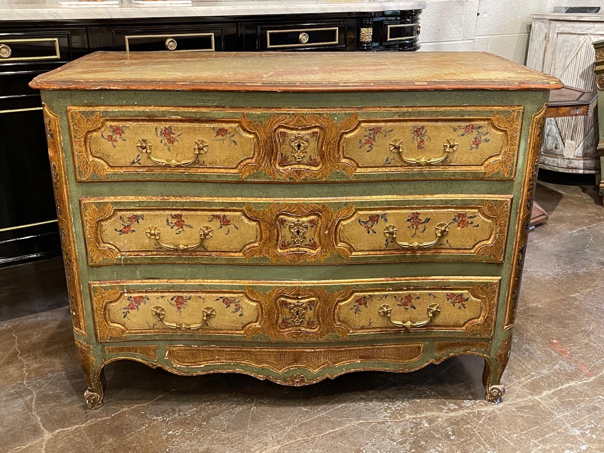 Lovely early 19th century French Louis XV style painted commode. Featuring beautiful floral images and the colors of gold, yellow, pink and green. A gorgeous decorative piece!!