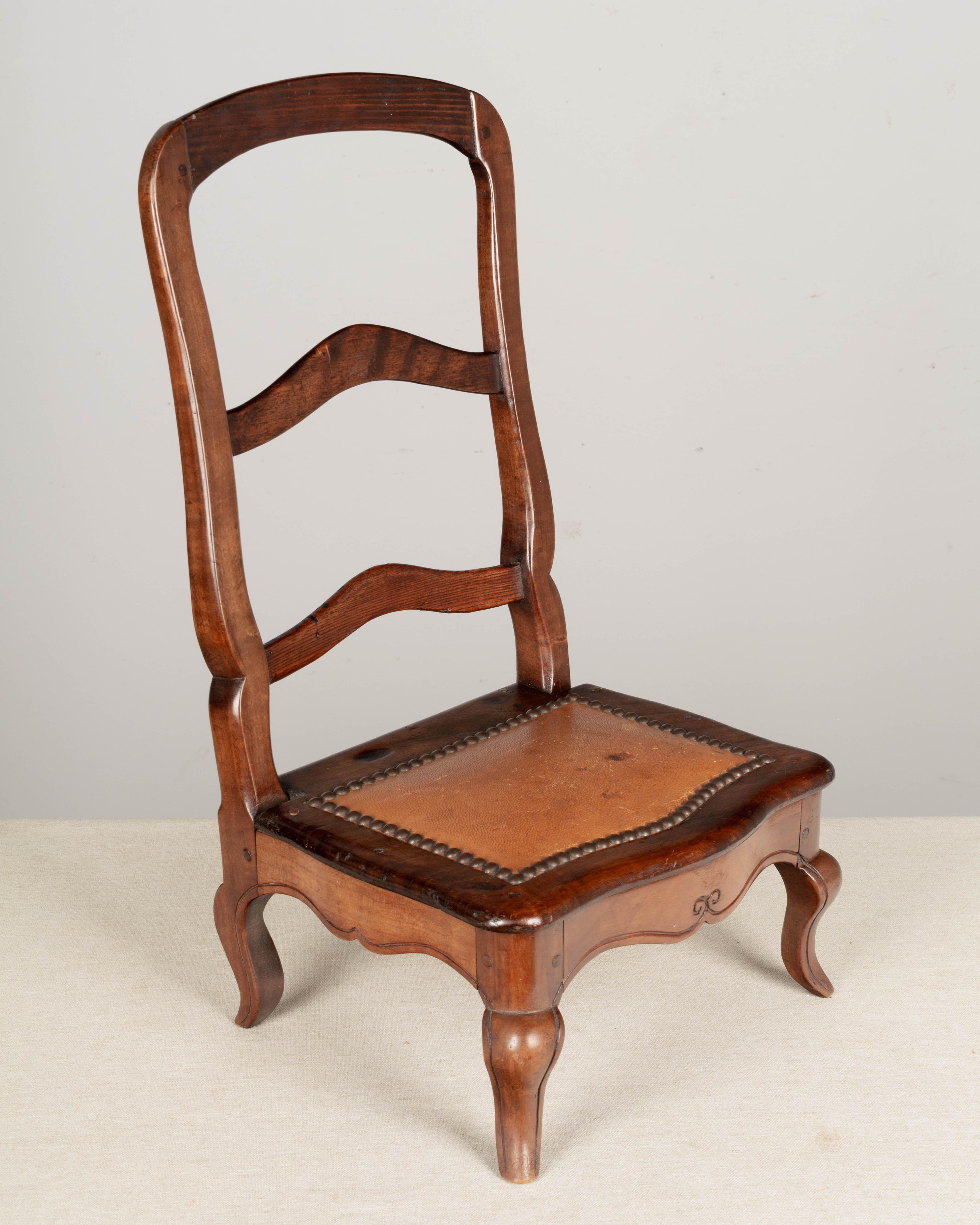 A 19th century Louis XV style Country French mahogany small sampler chair, hand-crafted by the furniture maker as an example of the style of chair that may be ordered. Ladder back with cabriole legs and leather seat with nail head trim. Pegged