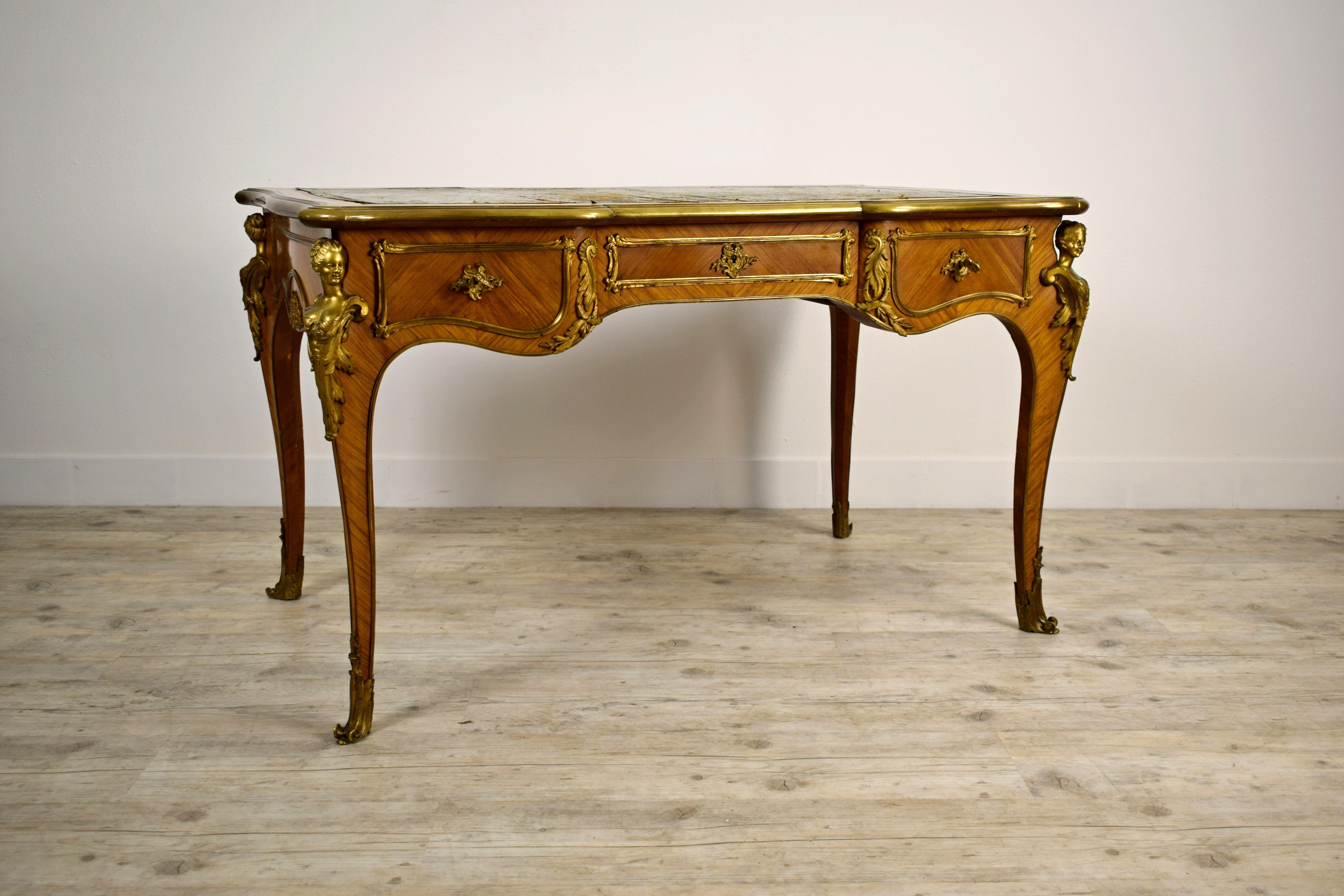 19th century, French Louis XV style wood centre desk with gilt bronze

This elegant centre desk, therefore finished on all four sides, was made in the 19th century in France, in the Louis XV style. The slightly wavy and curved top has a green