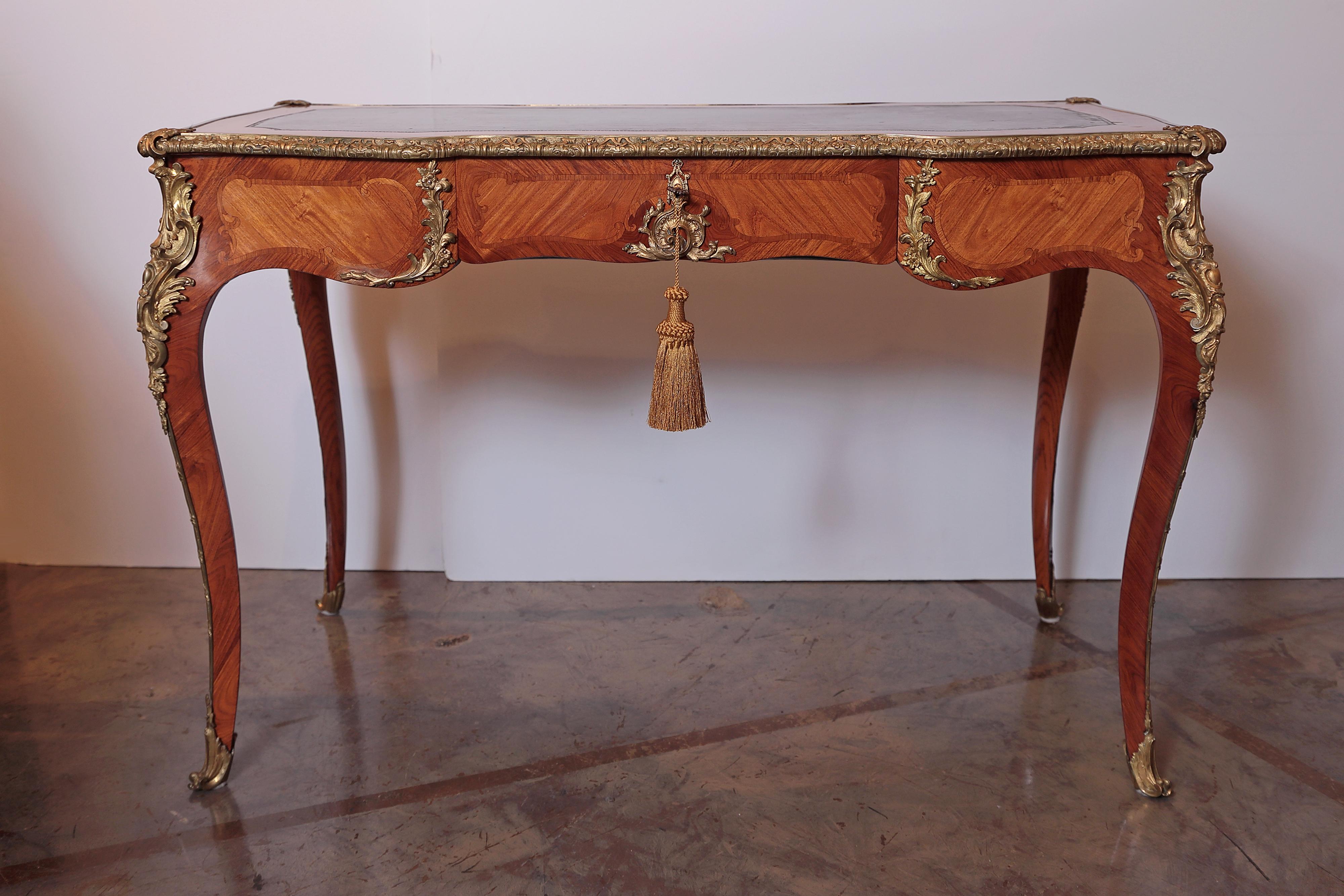 19th century French writing desk by Paul Sormani. Kingwood with parquetry inlay and a leather top. Three drawers and fine gilt bronze mounts.
