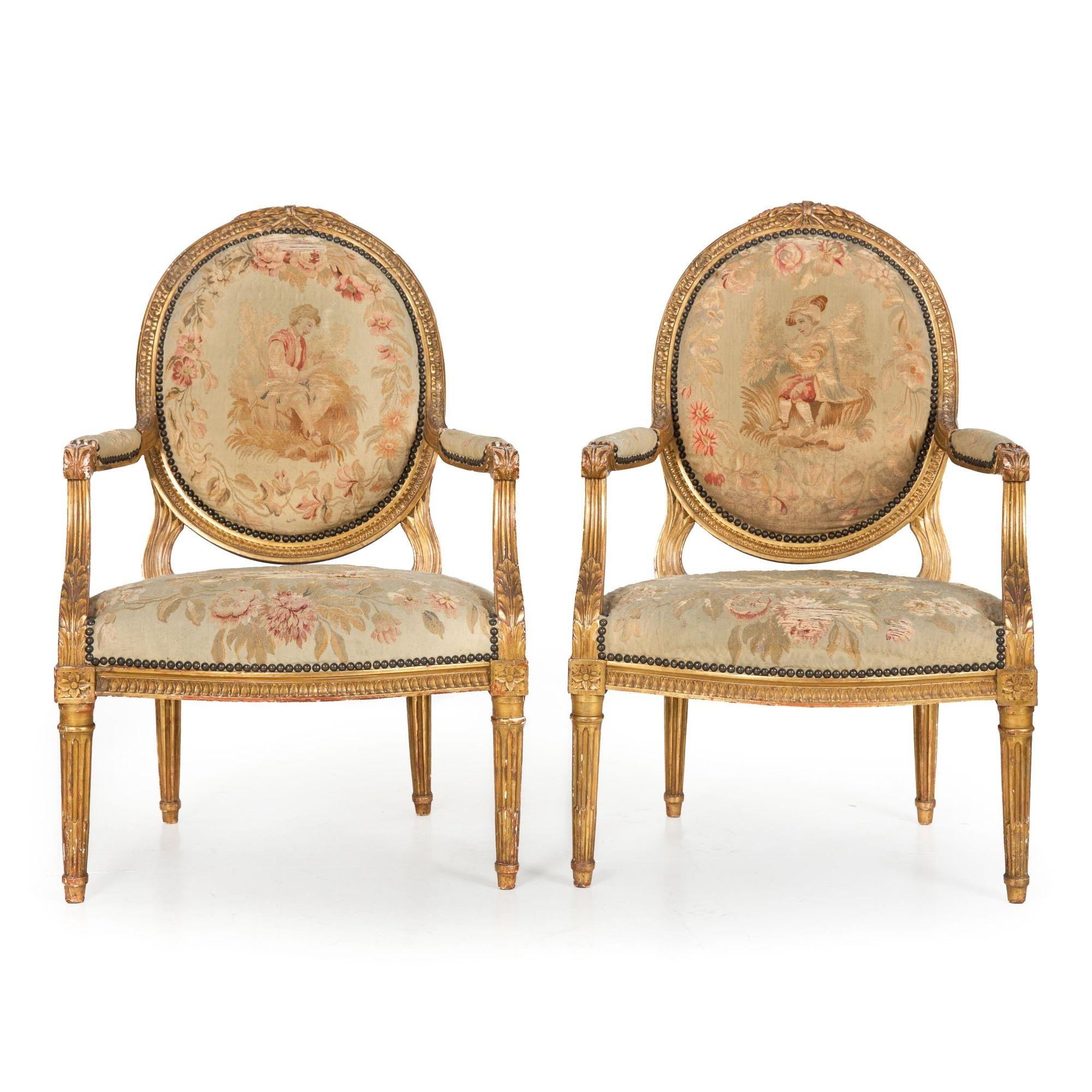  
A lovely 19th century pair of fauteuils in the typical Louis XVI taste with nicely carved solid beechwood frames covered in a thin layer of gesso over which a layer of red bole was applied before being overall gilded. The gilding has tarnished and