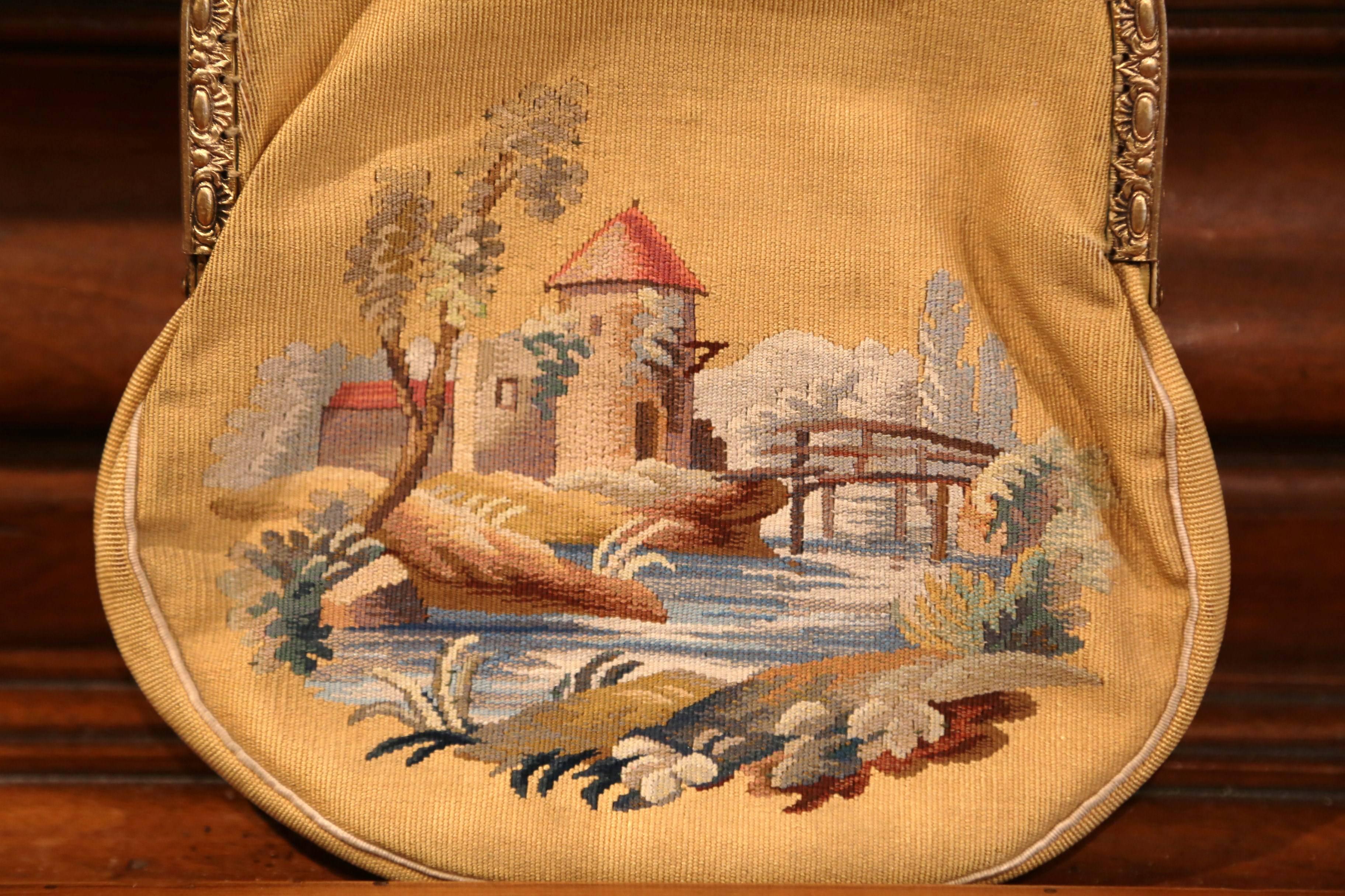 This elegant ladies purse was handwoven in France, circa 1860. The small, antique purse is handmade using colorful Aubusson tapestry. The tapestry features two different scenes. On one side of the purse, there is a young gentleman playing the flute