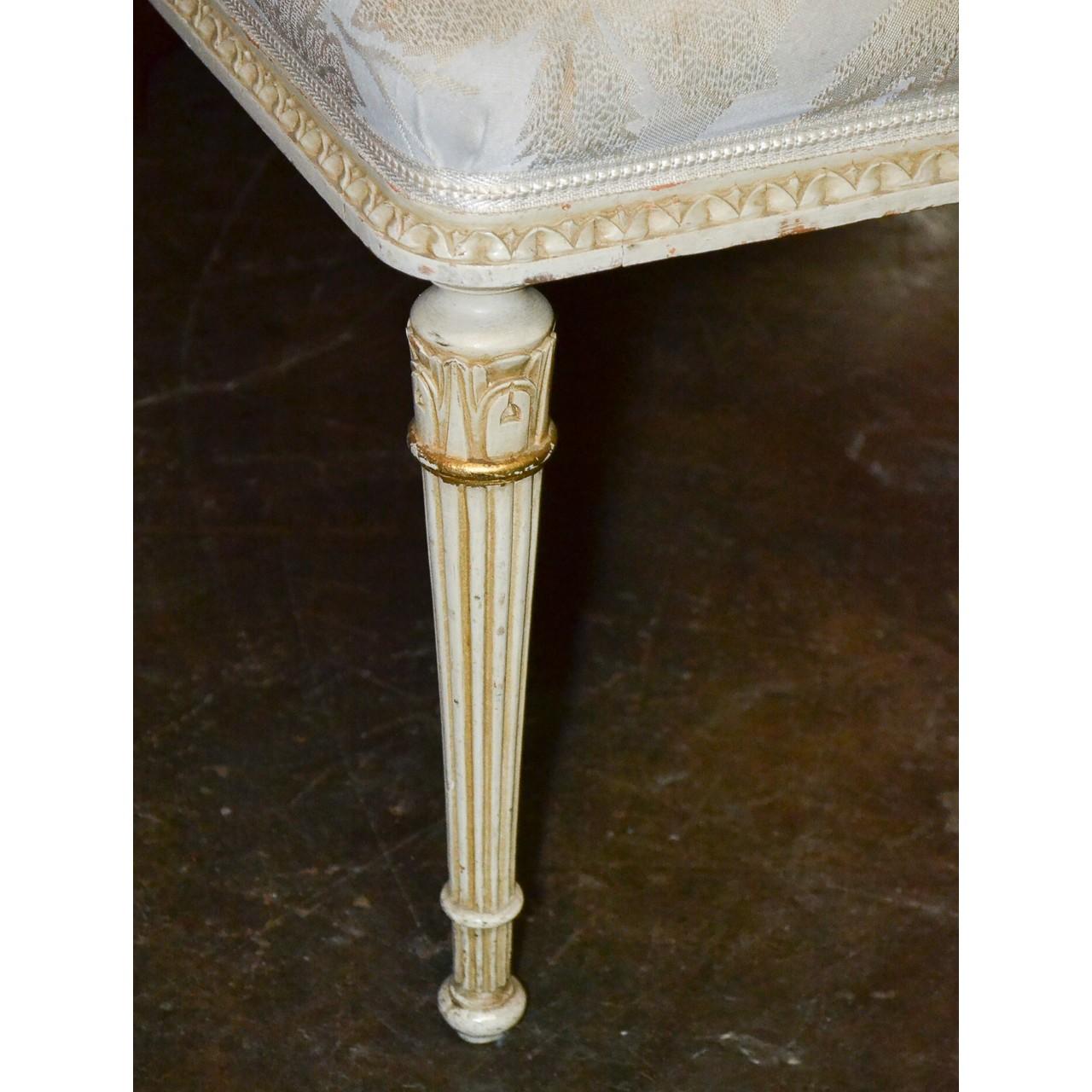 Elegant 19th century French Louis XVI style parcel-gilt and painted bench with upholstered top. Hard-carved and raise on tapered and fluted legs,

circa 1890.