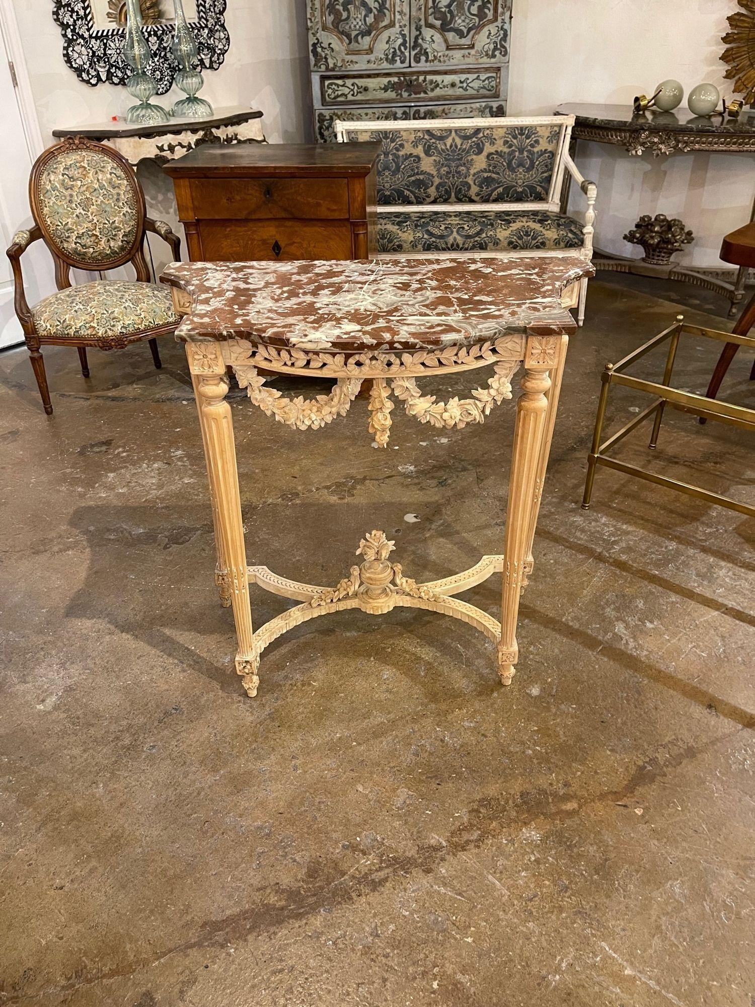 Gorgeous 19th century French Louis XVI carved and bleached walnut console with beautiful marble top. The carvings on this piece are exceptional. A true work of art. Exquisite!