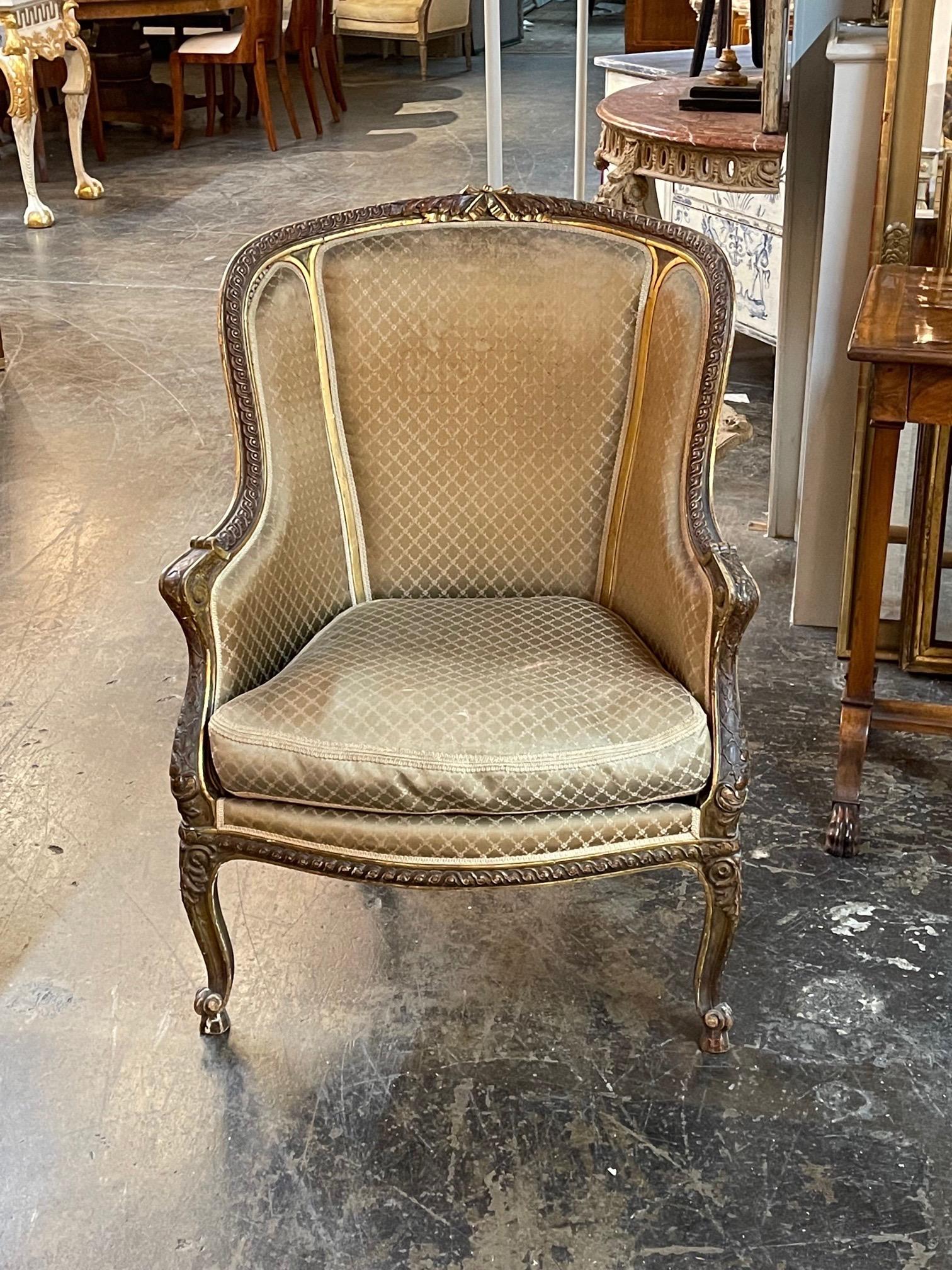 Handsome 19th century French Louis XVI carved and giltwood bergere. Beautiful carvings and upholstered in a tan fabric. Very elegant!