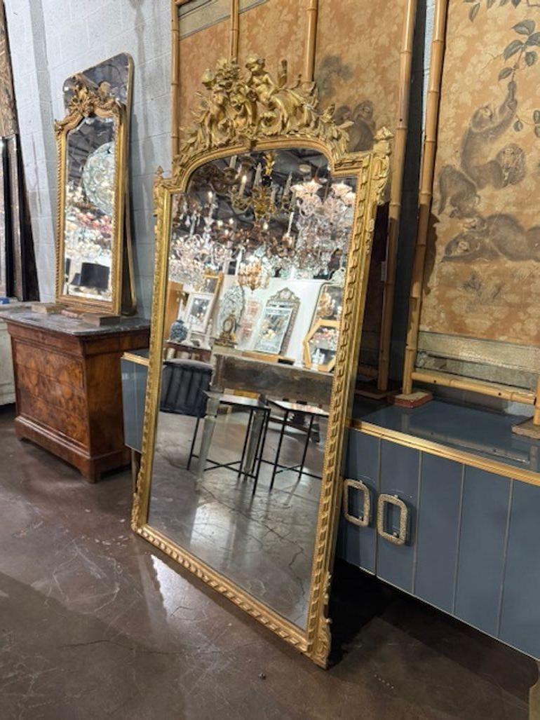 This 19th Century French Louis XVI Carved and Giltwood Mirror exudes elegance and sophistication with its intricate detailing and beautiful patina. This mirror captures the essence of French classic design.  Exceptional craftsmanship and timeless