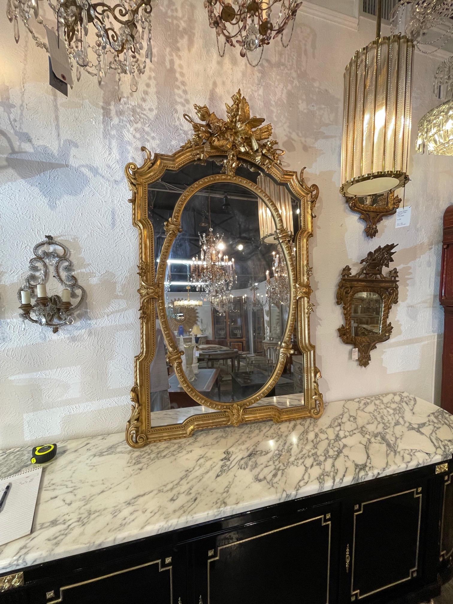 Exquisite 19th century French Louis XVI carved and giltwood mirror. Amazing carvings including floral images, ribbons and birds. A real work of art!!
