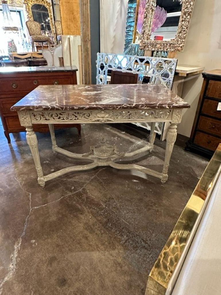 Lovely 19th century French Louis XVI carved and painted center table with original rouge marble top. Beautiful patina and carvings on this piece. Outstanding!!