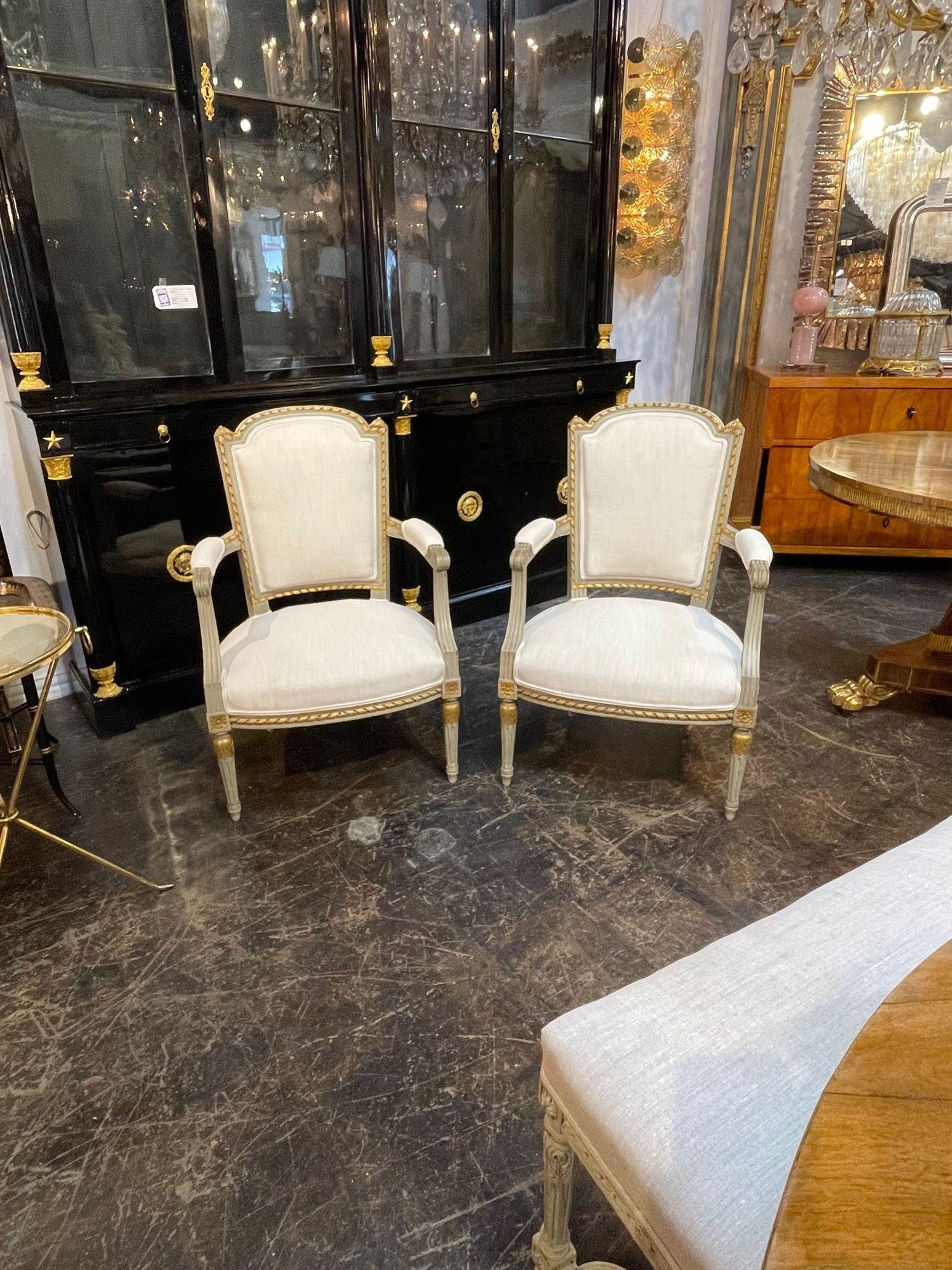 Exceptional pair of 19th century French Louis XVI carved and painted chairs with creme colored linen upholstery. Very fine carvings and beautiful patina as well. Creates an elegant look!!