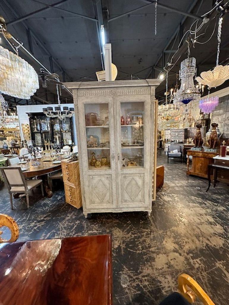 Beautiful 19th century large scale French Louis XVI carved and painted display cabinet. This piece has a very fine patina and ample space to show off your treasures. Lovely!