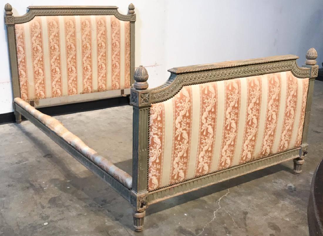 Exceptional 19th century French Louis XVI style bed with finely detailed carving overall of acanthus leaves, flutes, and acorn finials. Beautiful fabric upholstery in a ribbon, tassel, and flower spray motif. Original patina,

circa