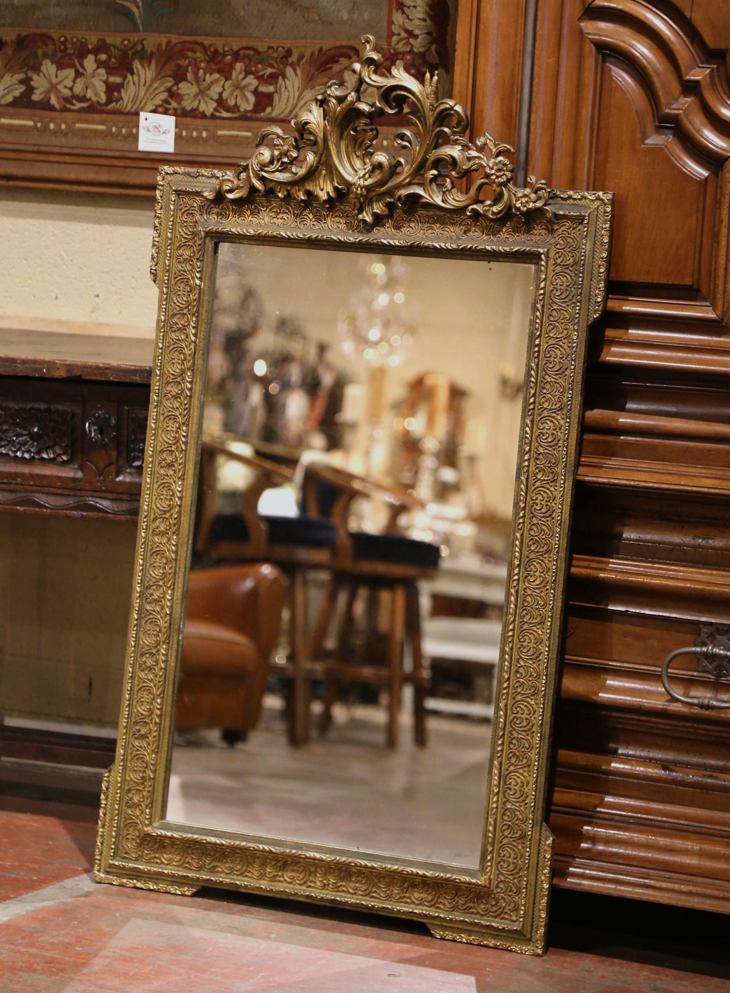 Eleganza per la stanza della polvere o per l'ingresso con questo elegante specchio dorato antico! Realizzato in Francia, intorno al 1870, l'ornato frontone traforato presenta un cartiglio a foglia d'acanto vorticoso, affiancato da decorazioni a