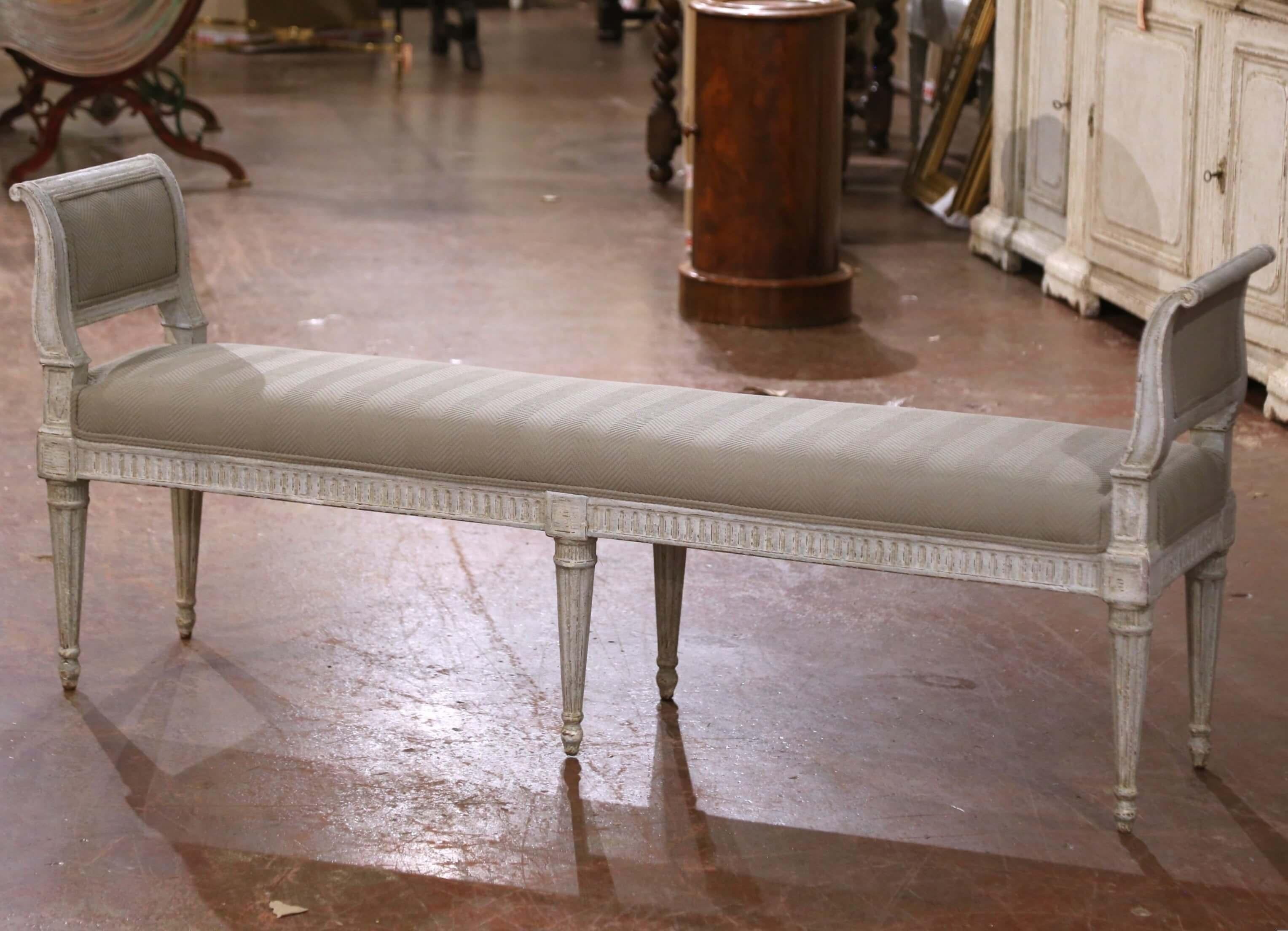 Place this refined antique banquette at the foot of a king-size bed or along a hallway wall for elegant, versatile seating. Crafted in France circa 1880, the piece is a classic example of Louis XVI style, standing on six fluted and tapered legs with