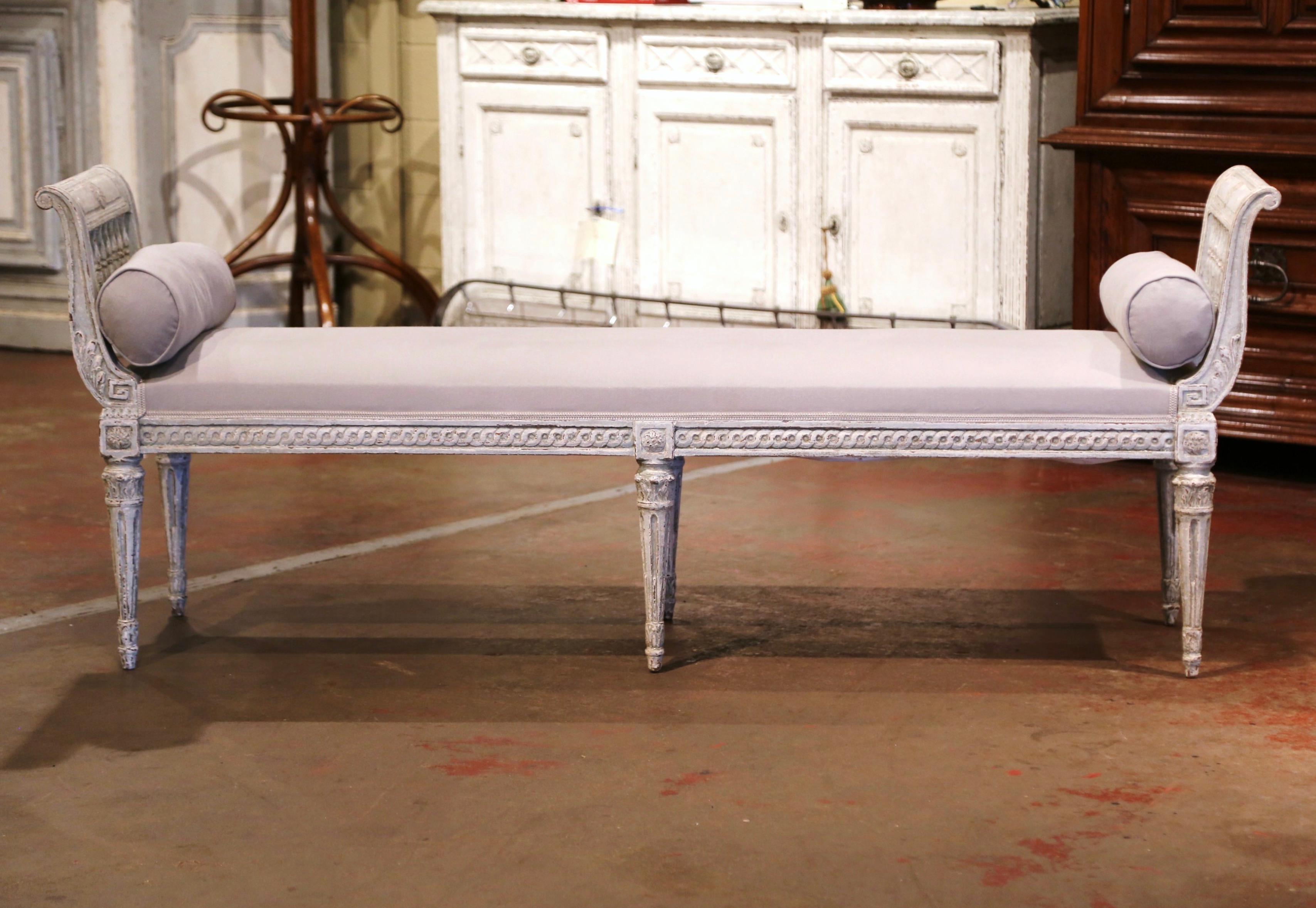 Place this elegant antique six-leg bench at the foot of a king size bed or in your living room for extra, versatile seating. Crafted in France, circa 1880, the traditional banquette stands on six tapered and fluted legs embellished with carved